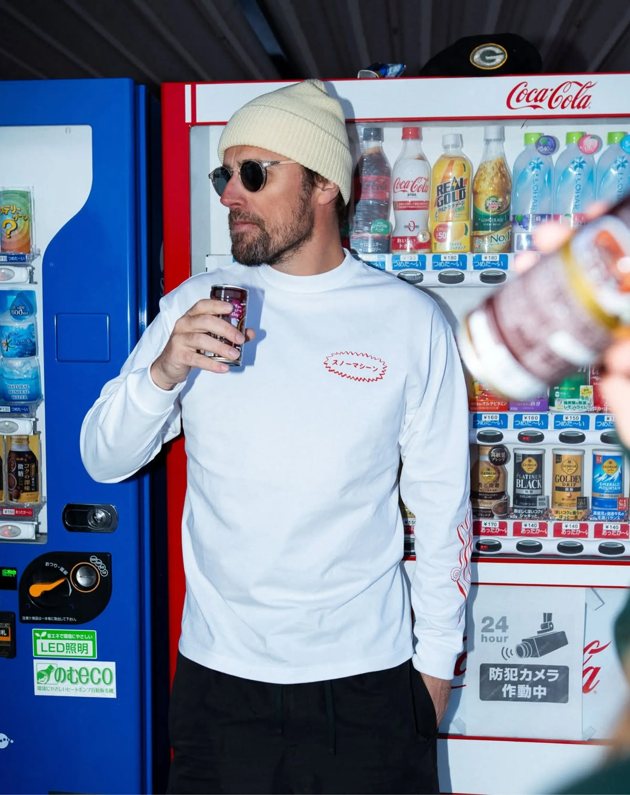 Snow Machine Japan white long-sleeve tee, photographed at a Japanese vending machine