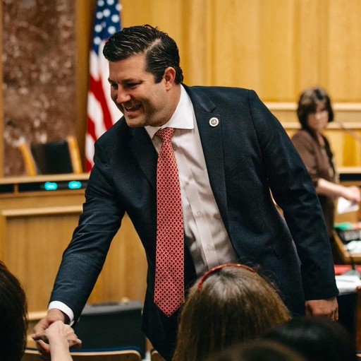 Rick Ward smiling and shaking someone's hand