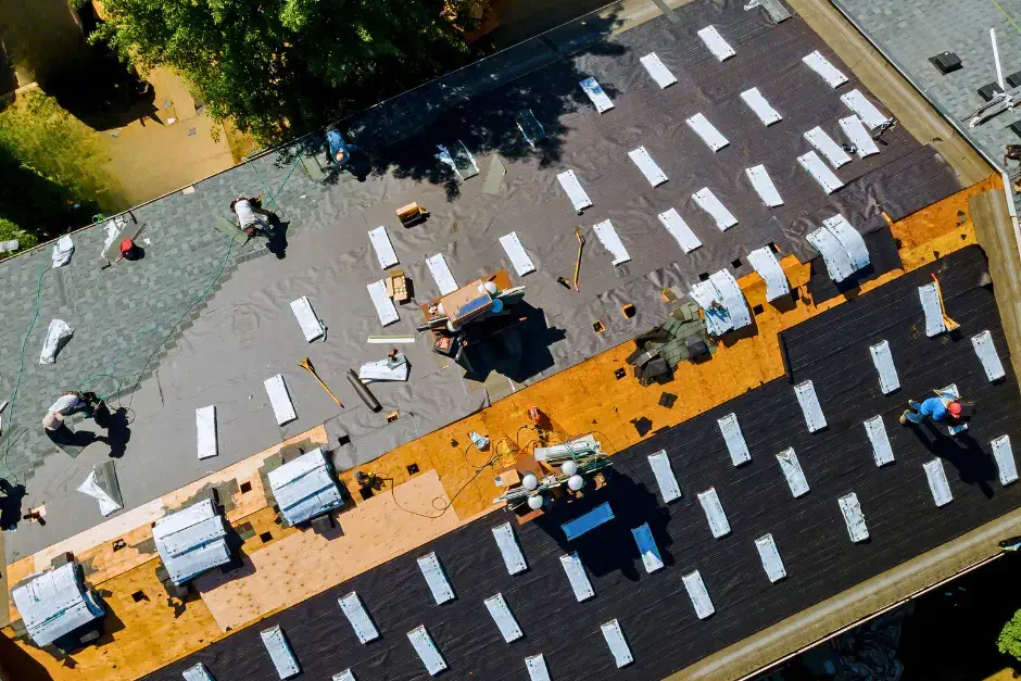 aerial photo of roofers replacing roof