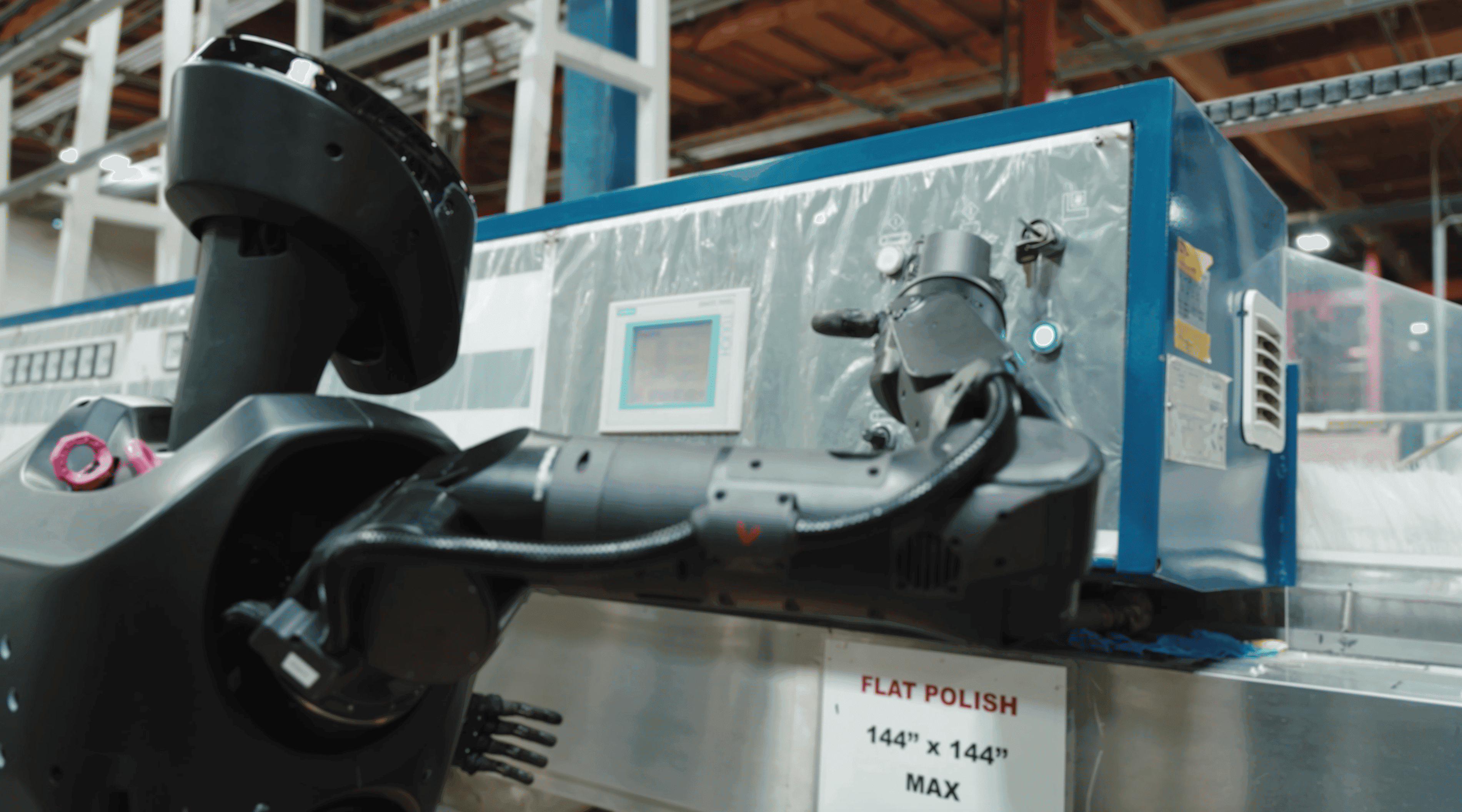 Robot system processing glass panes in factory environment.