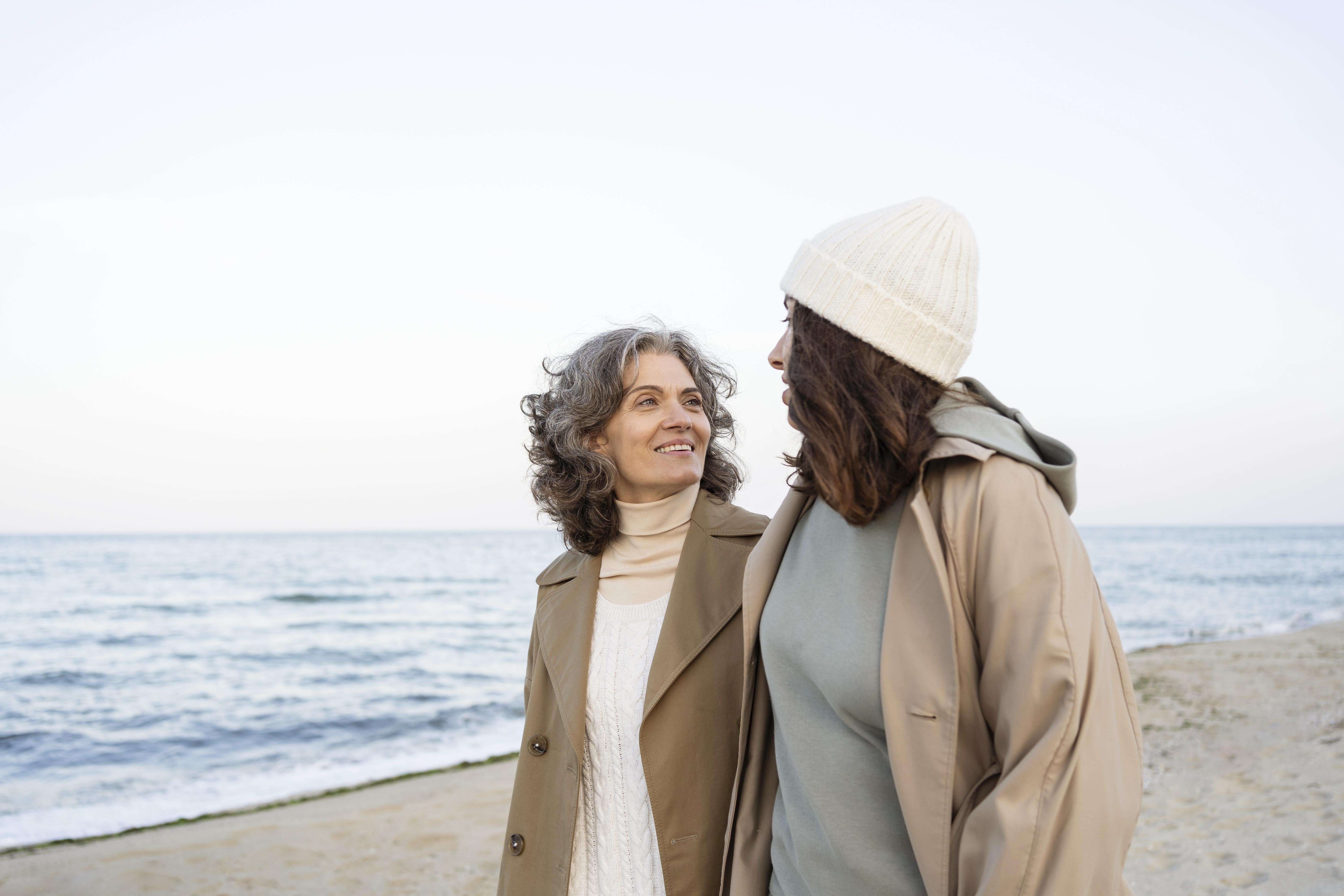 Mother and dauther walking at the beach