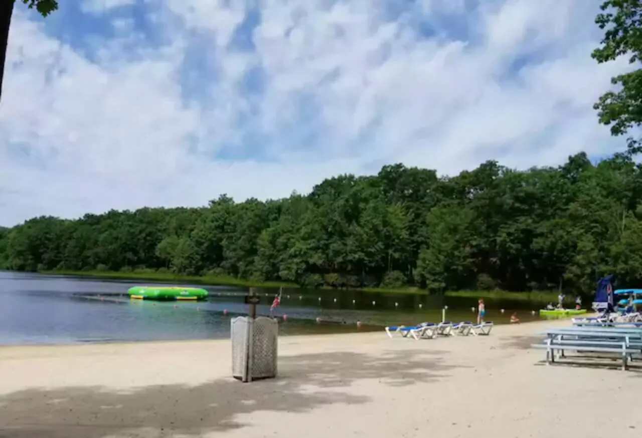 Boulder Lake Club sand beach with lake and wooded shore, Big Boulder, Lake Harmony, PA