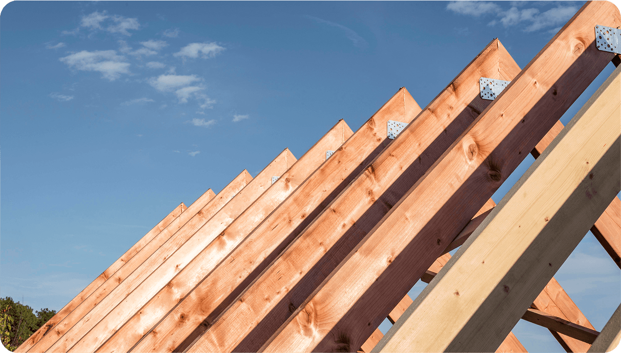 wooden rafter structure -support fir the roof, skyes on the background