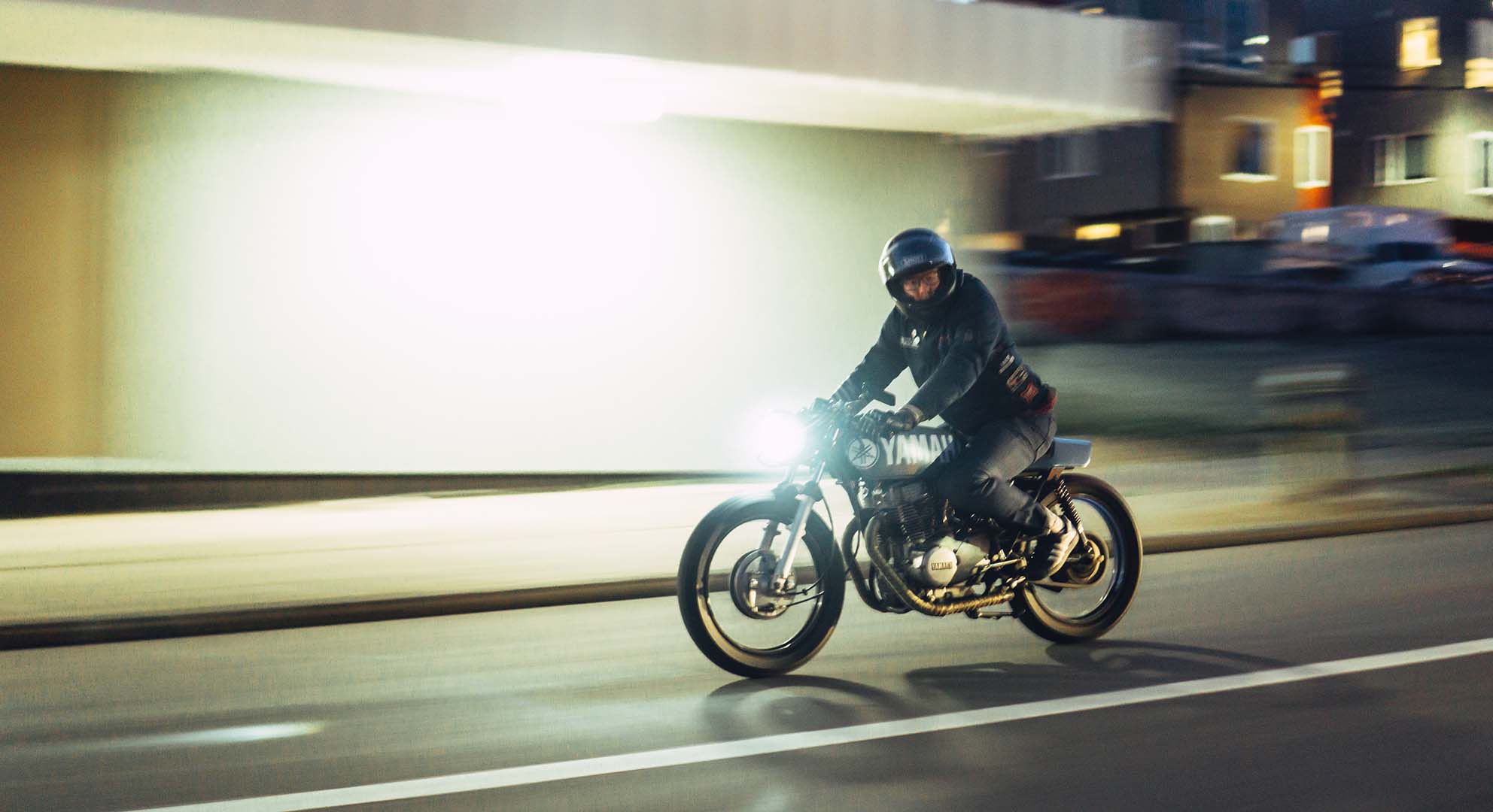 Bobby Hougham riding a motorcycle at night — a creative leader known for bold, forward-moving ideas and storytelling in motion design.