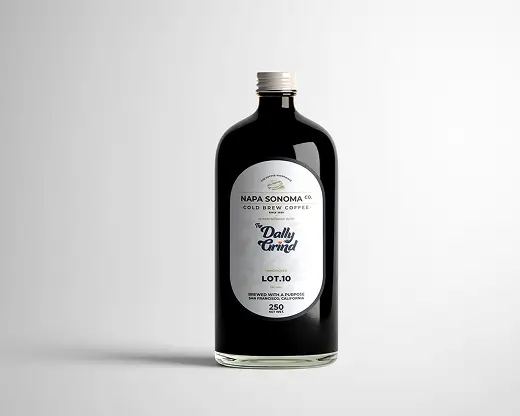 The Dally Grind Coffee brand packaging: Black logo and white label design on a glass bottle.