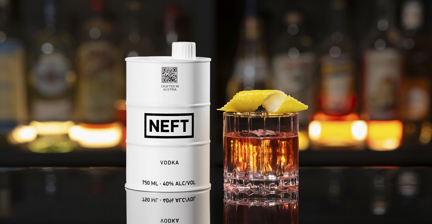 A NEFT Barrel and a glass of Sazerac on a bar counter.