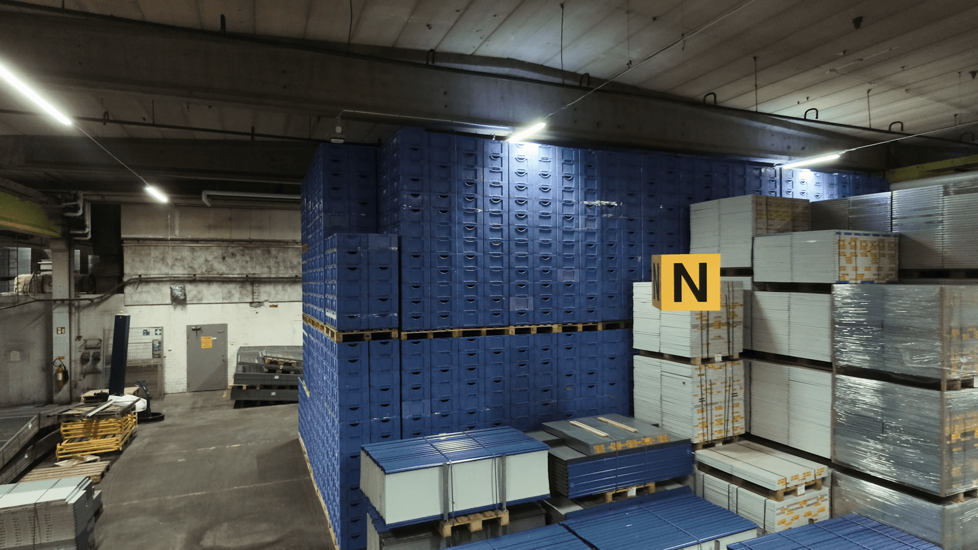 A yellow forklift in a large warehouse