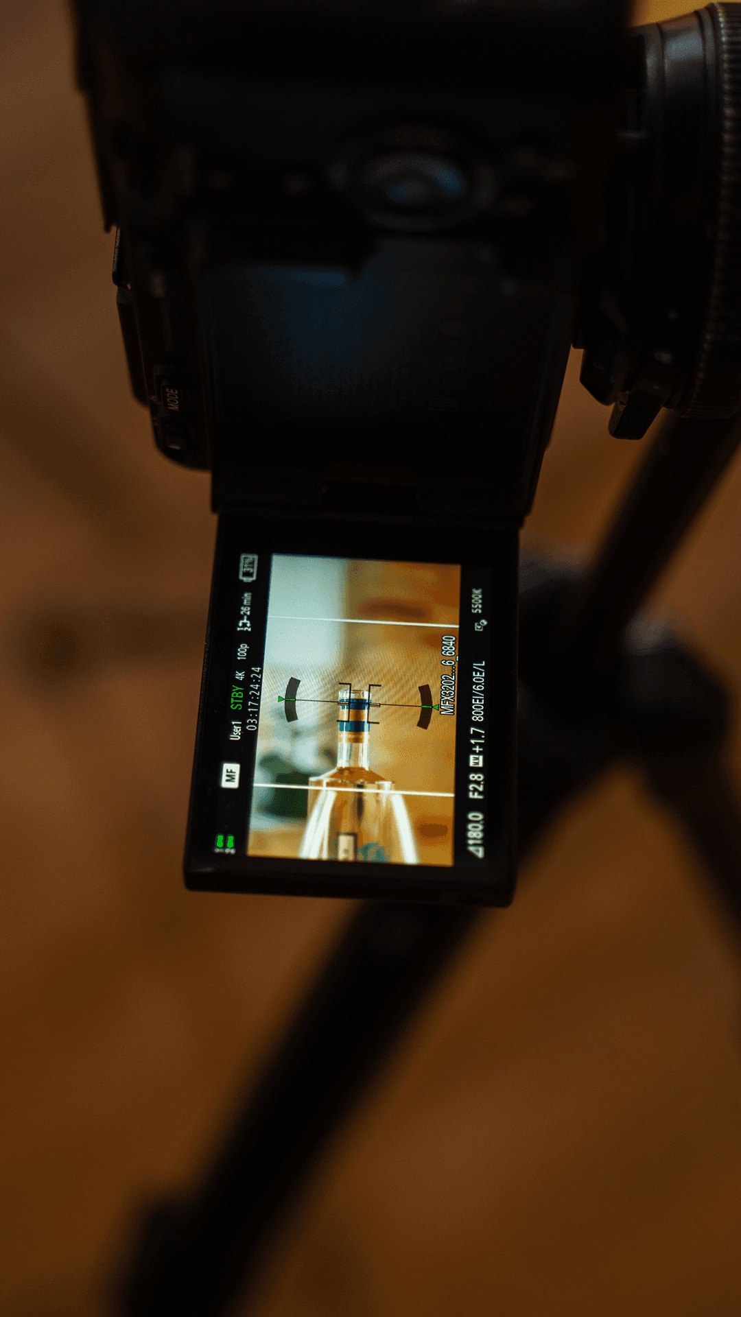 Abstract sculpture with eight teardrop-shaped arms radiating from the center, alternating in black and white, set against a soft gray background. Modern, symmetrical.
