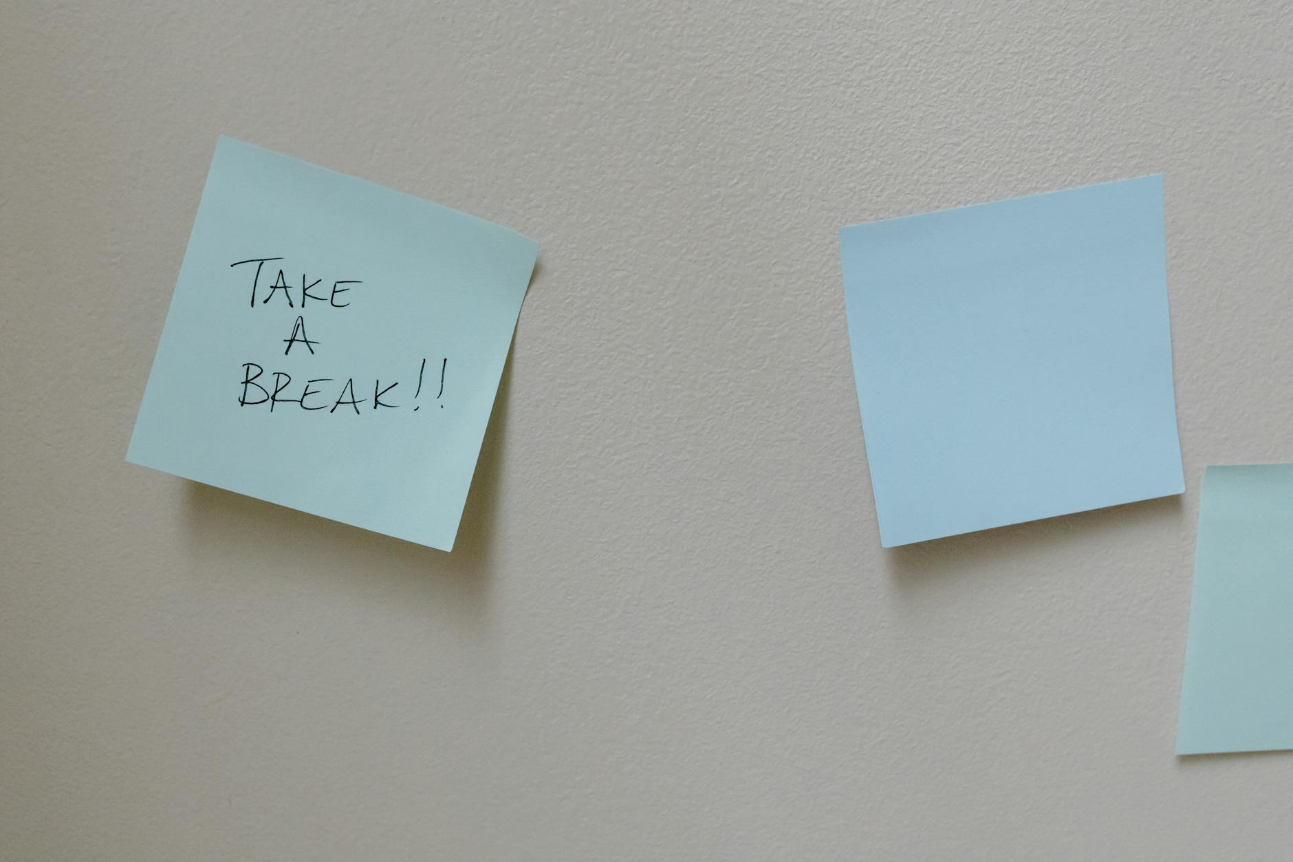 Close-up of a teacher's hands organizing colorful sticky notes on a wall to map out a complex curriculum flow.