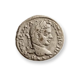 Close-up of an ancient coin with engraved profile and markings
