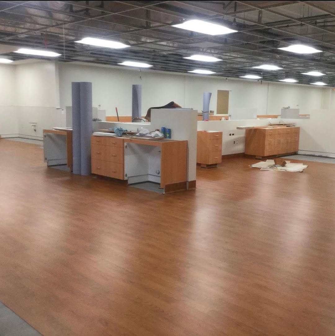 Finished wood-look sheet vinyl floor installed around clinic casework