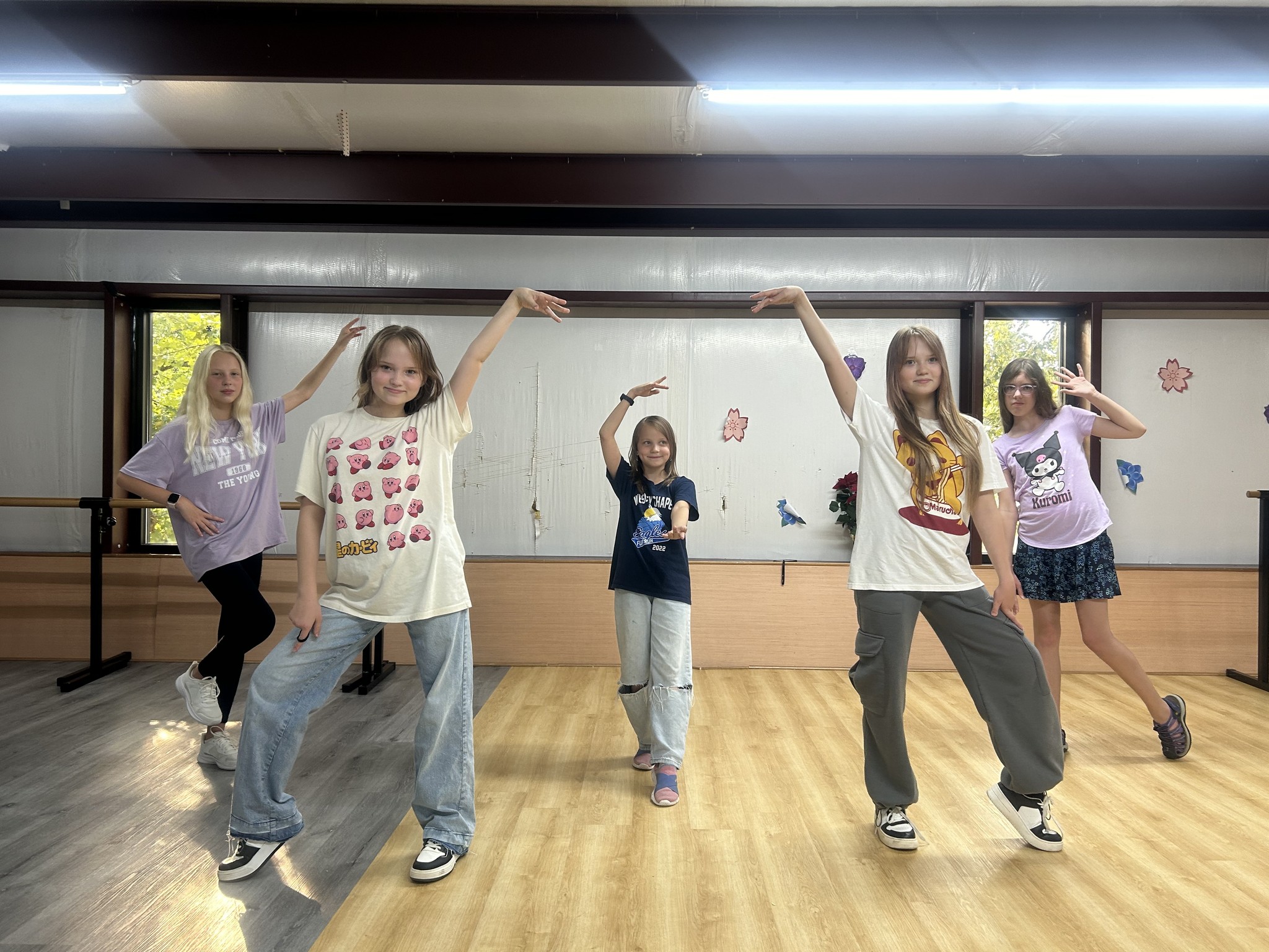 Girls from the SportPlus hip hop class striking a group pose in the SportPlus Charlotte dance studio