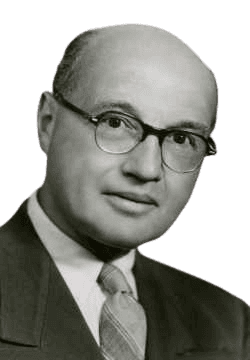 Chemist and Nobel laureate Fritz Lipmann is shown in this black-and-white portrait, wearing glasses, a suit, and a patterned tie with a calm expression. Lipmann is best known for his discovery of coenzyme A, a crucial molecule in cellular metabolism, which significantly advanced our understanding of biochemical energy transfer.