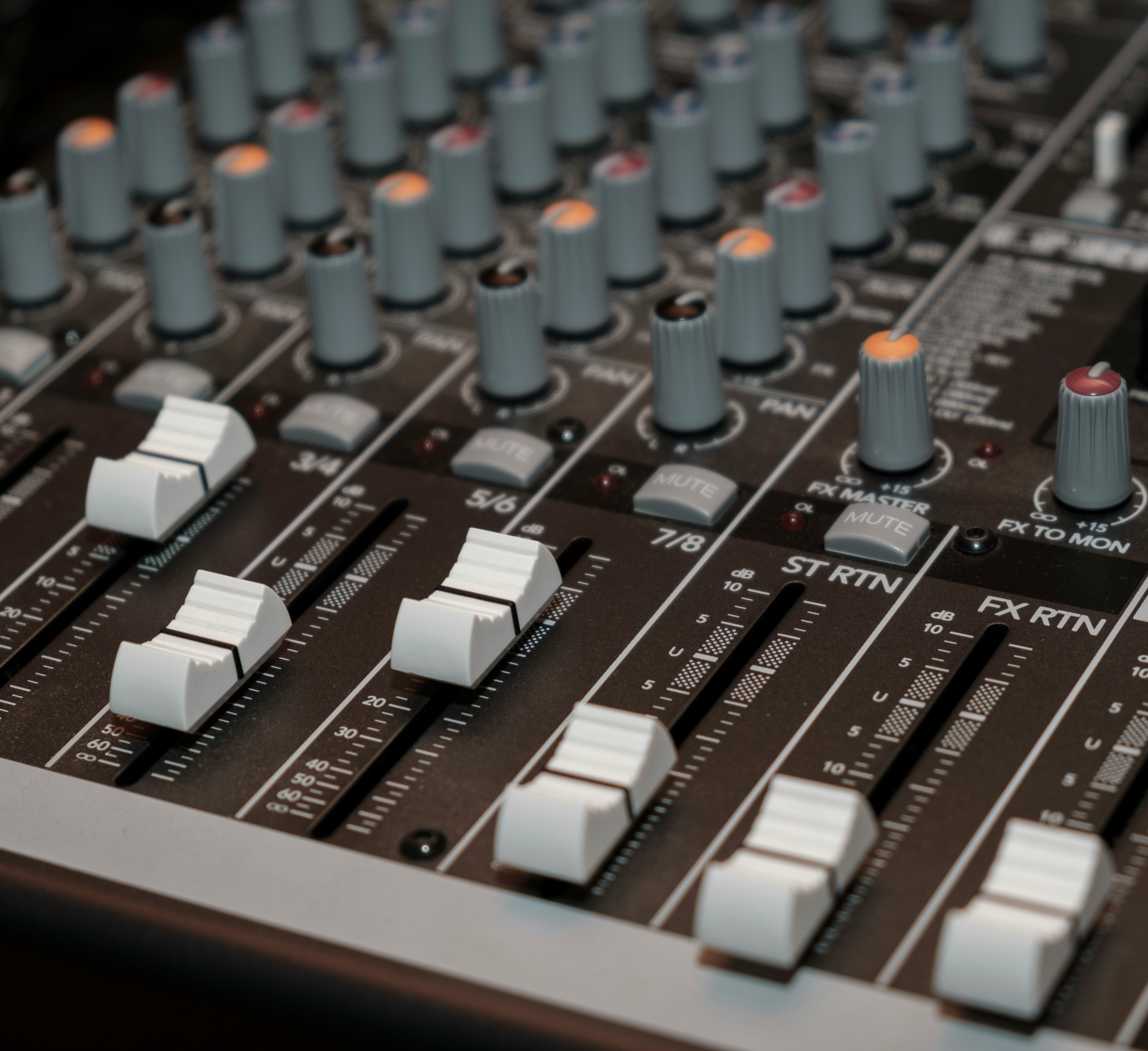a close up of a mixing board with knobs