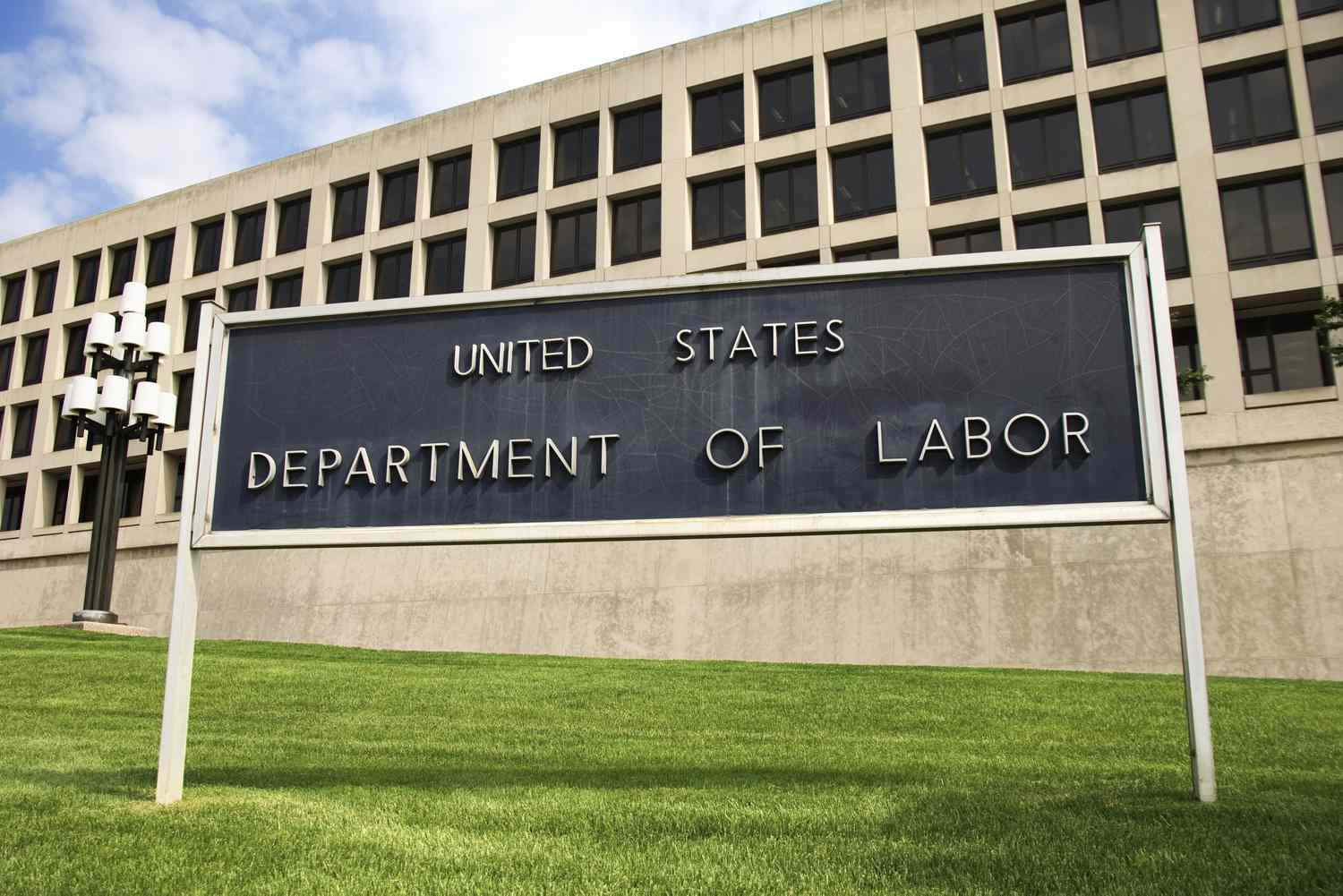 United States Department of Labor building with a prominent sign in the foreground, located in Washington, D.C.