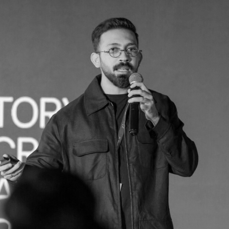 Woman working at desk with laptop and phone.