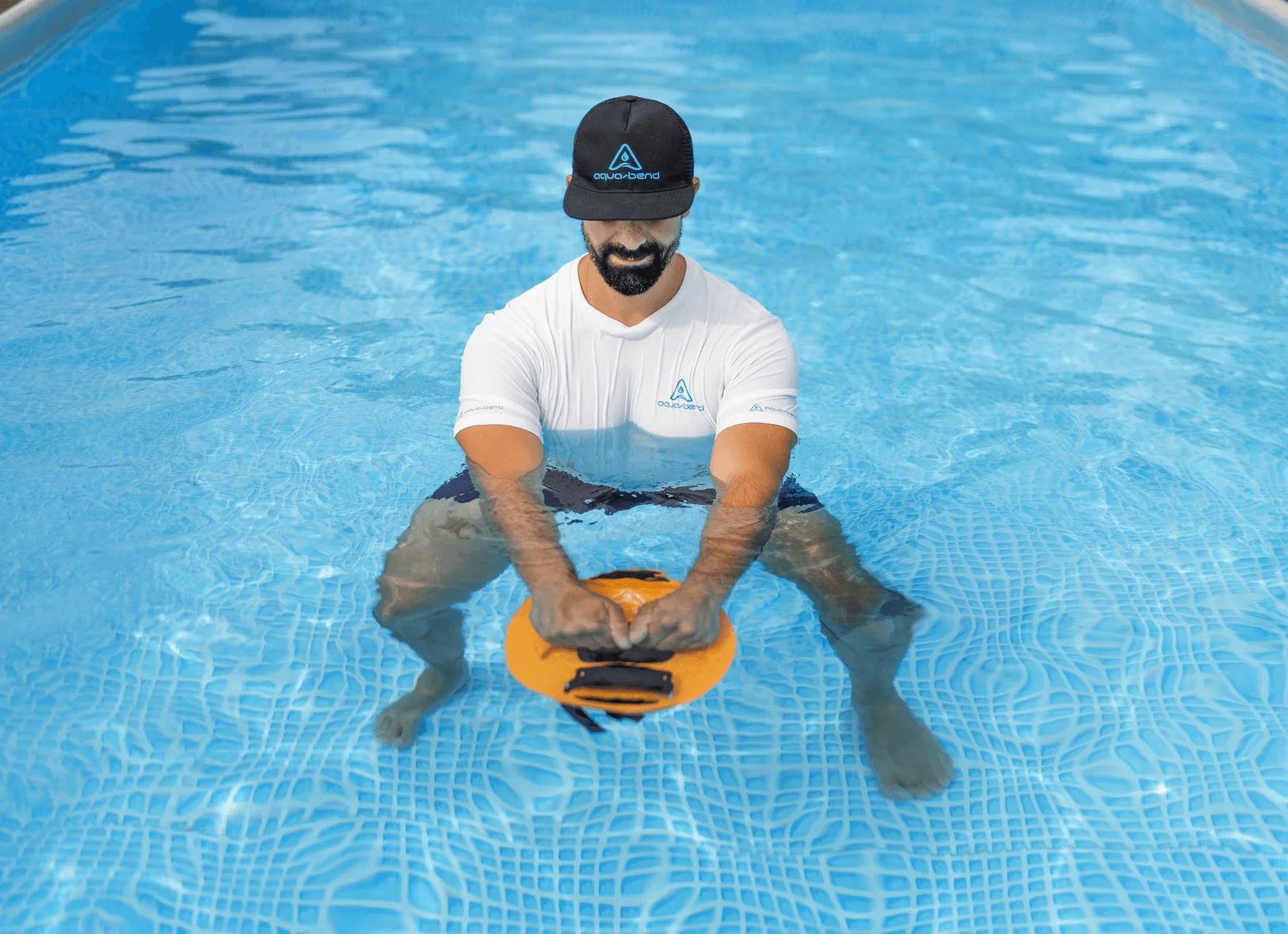 Man performing a kettlebell-style Aqua-Bend swing in water using both hands on the disc