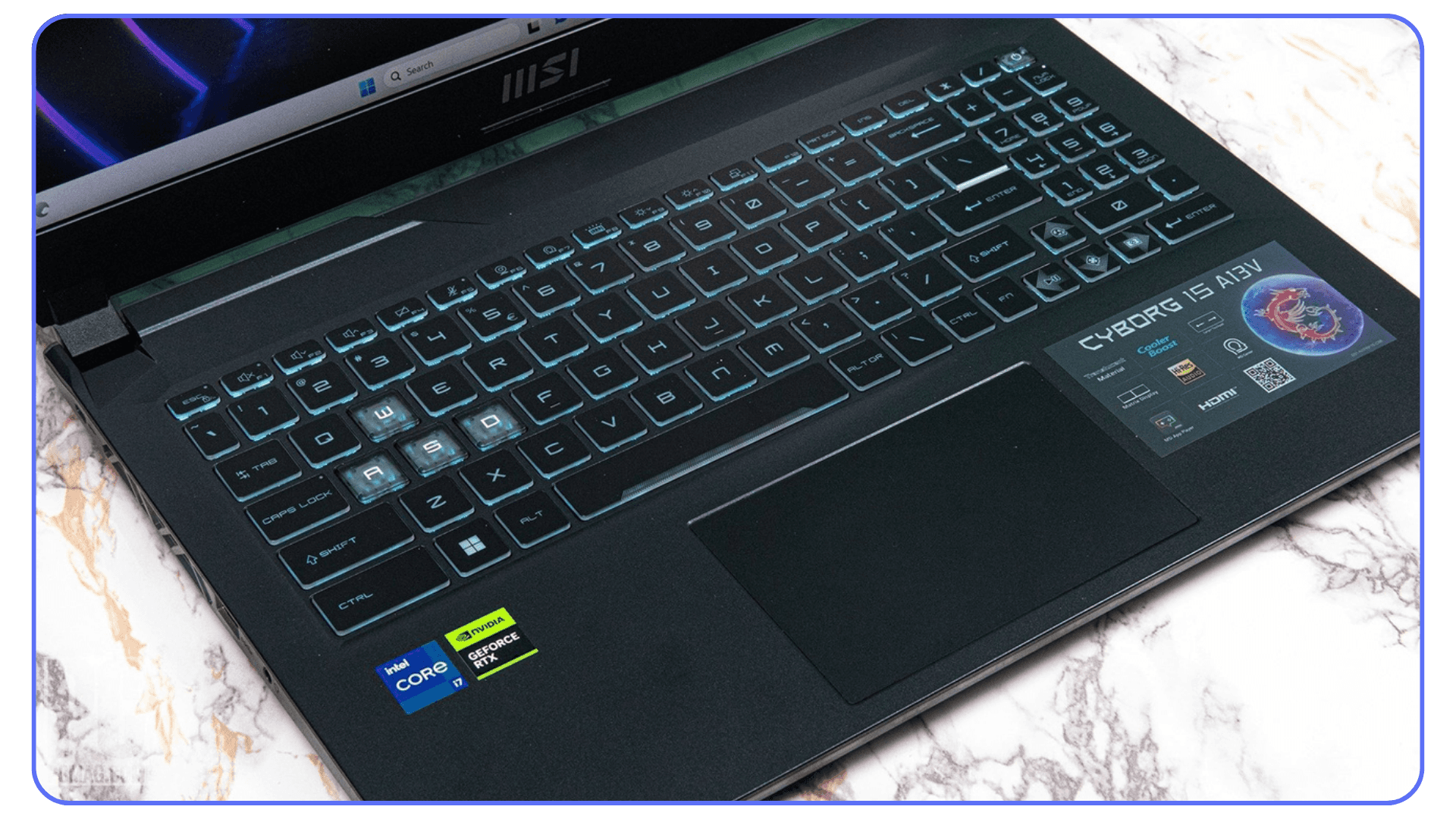 A close-up of the MSI Cyborg 15 laptop's keyboard and touchpad, showing glowing blue keys and an NVIDIA GPU sticker.