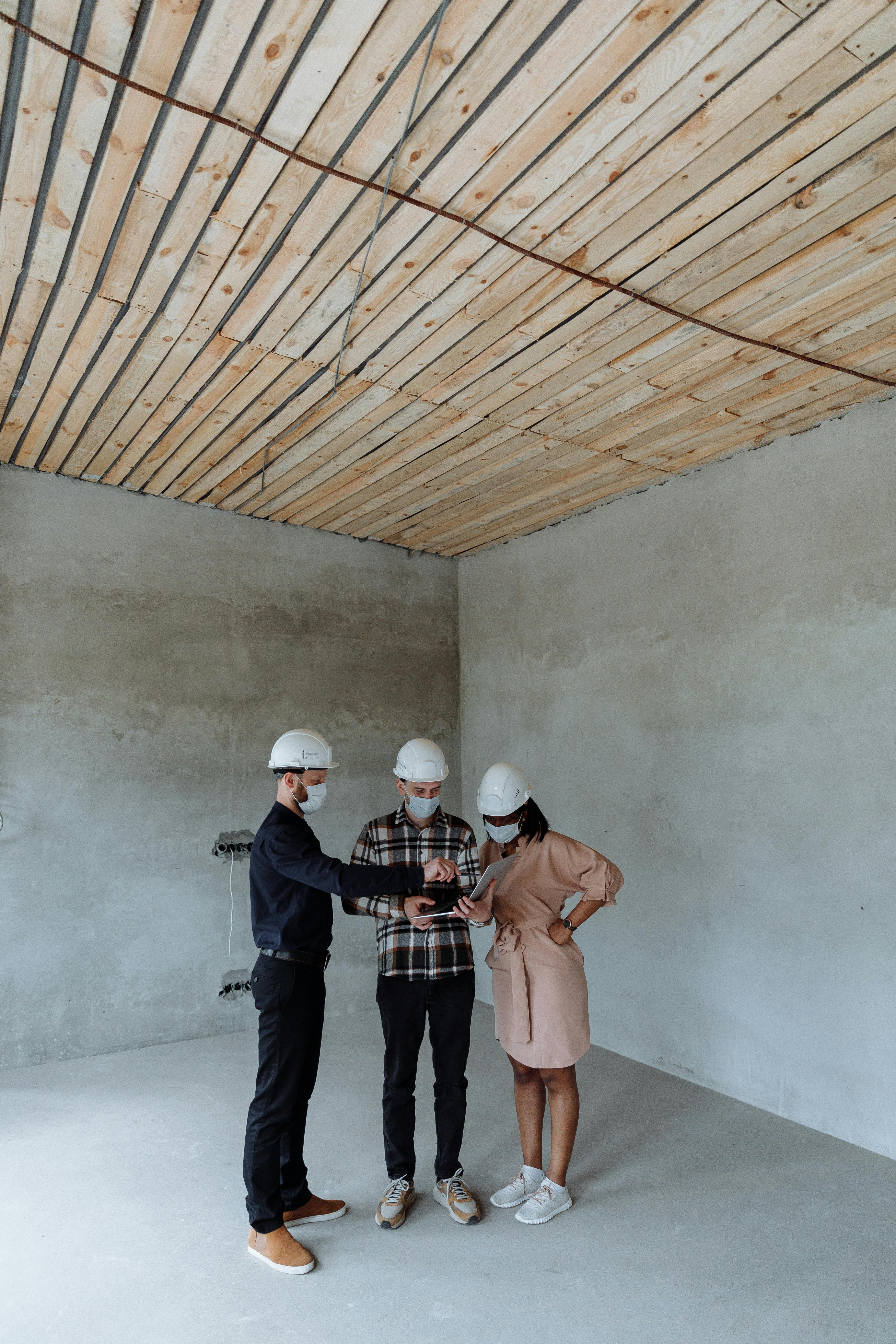Contractor and sales representative reviewing plans on site