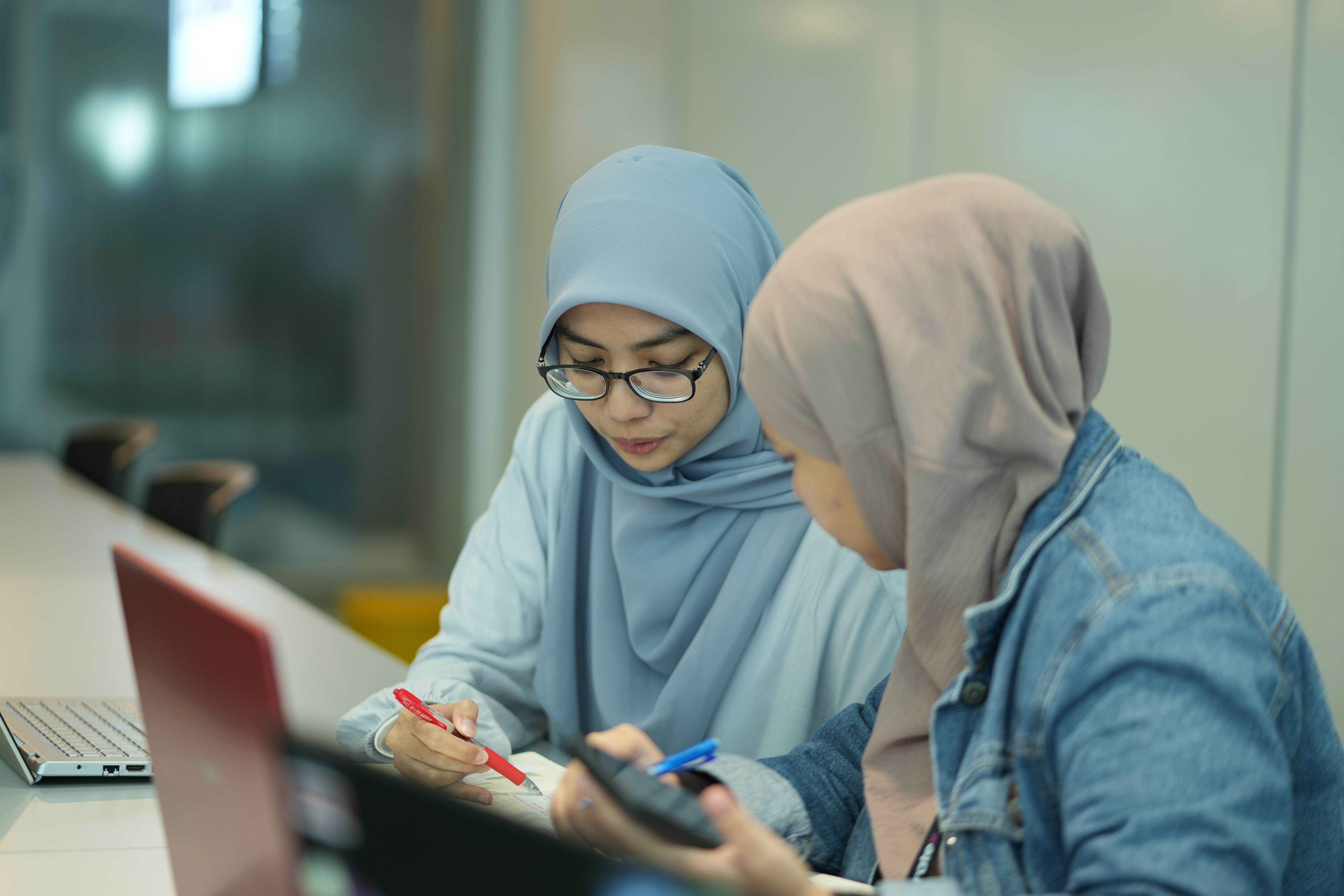 Image of women proudly displaying their CompTIA certifications, showcasing empowerment and achievement in tech careers.
