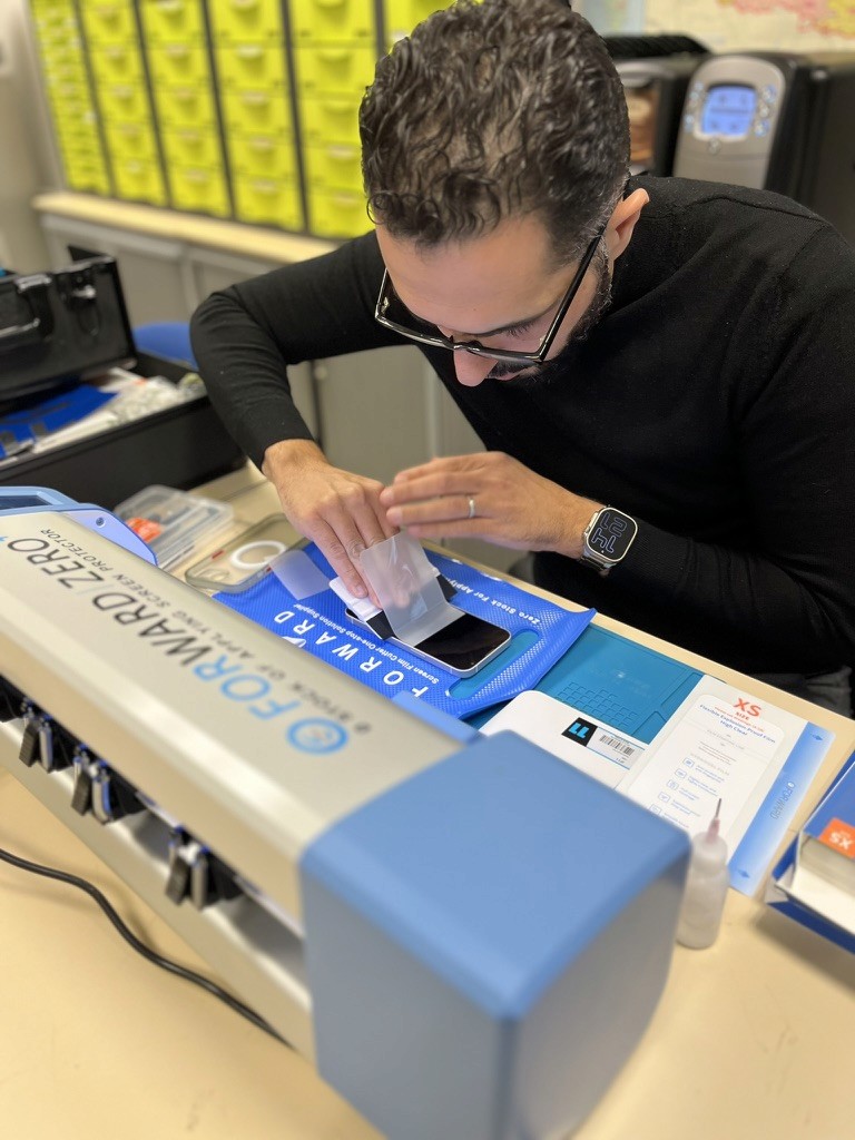 people sitting on chair in front of table while holding pens during daytime