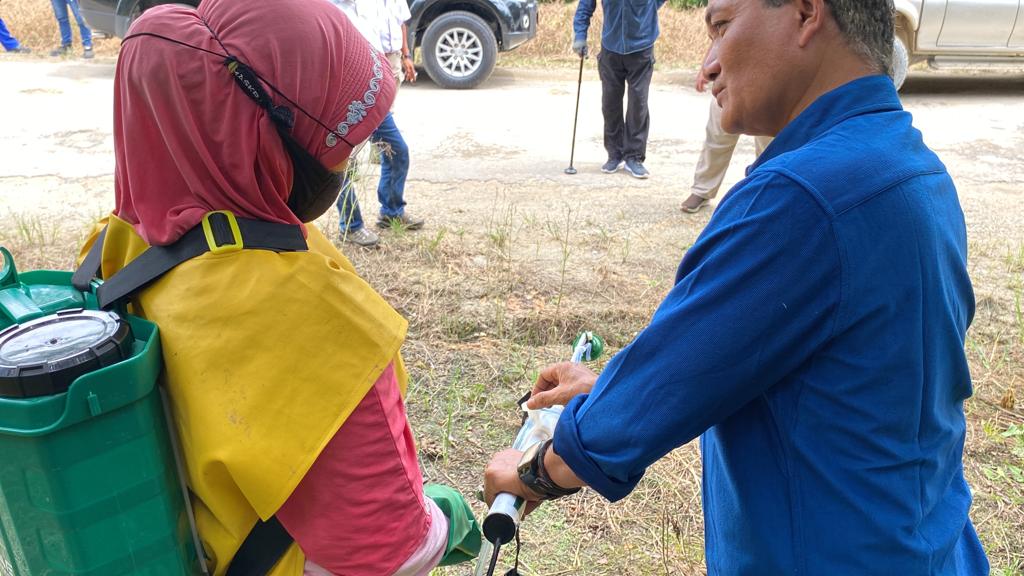 Woman standing in front of a white modern car in a futuristic bulding
