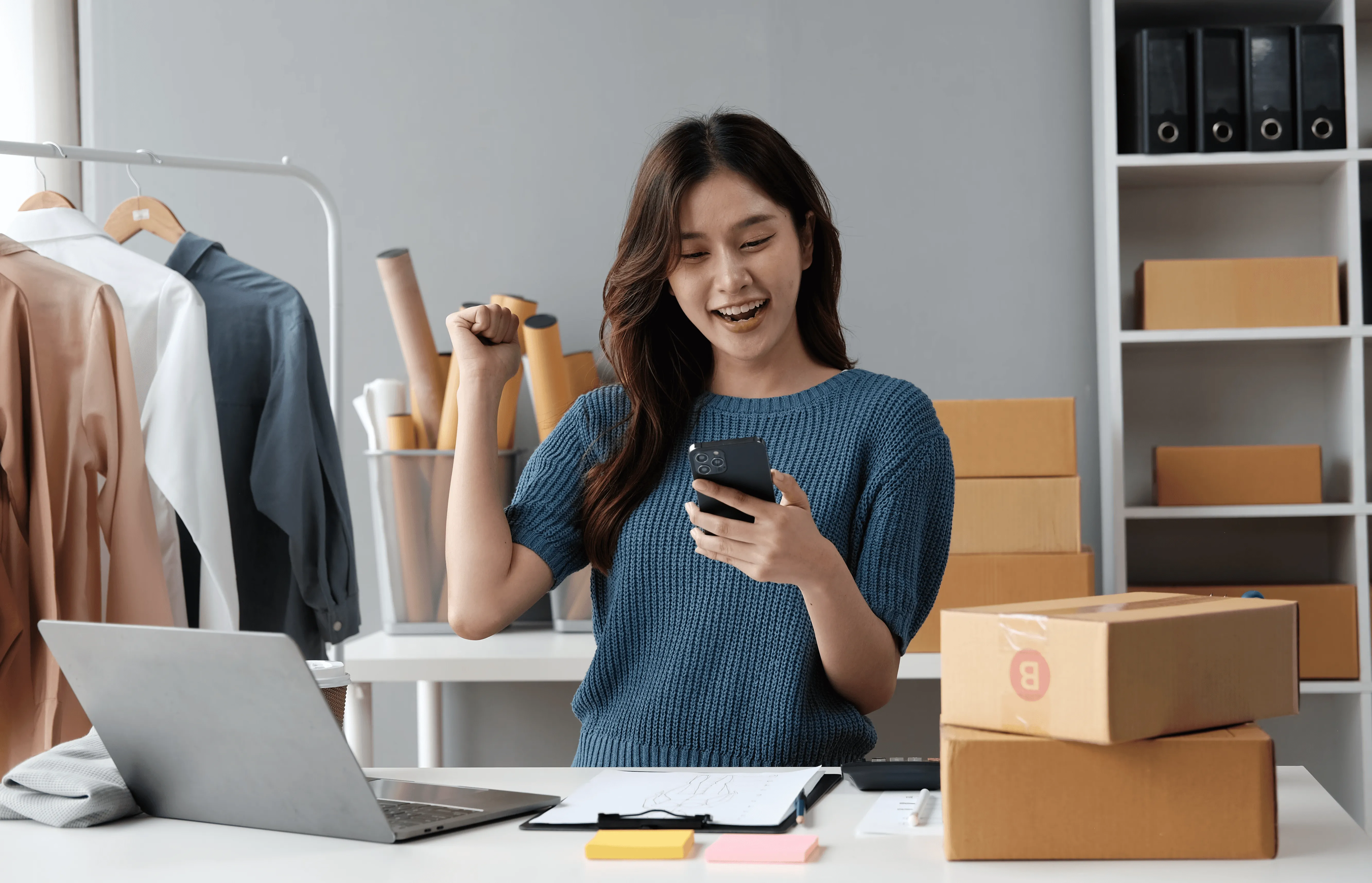 Retail business owner managing online orders alongside POS system.