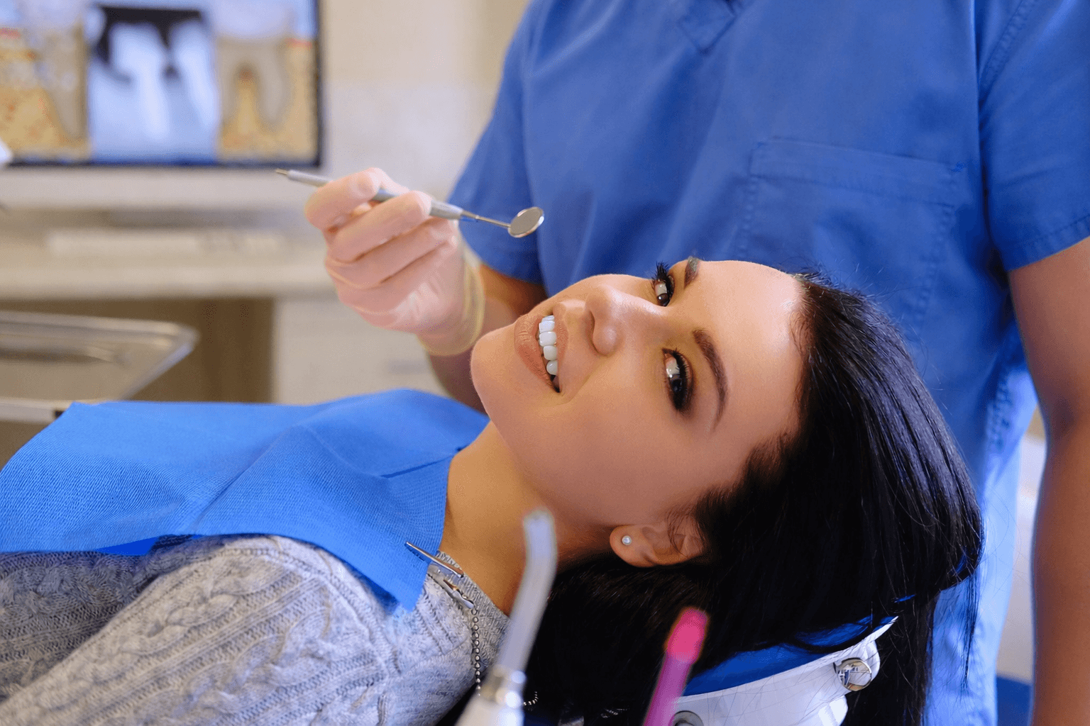 Dentist performing professional teeth cleaning on a patient in a clinic