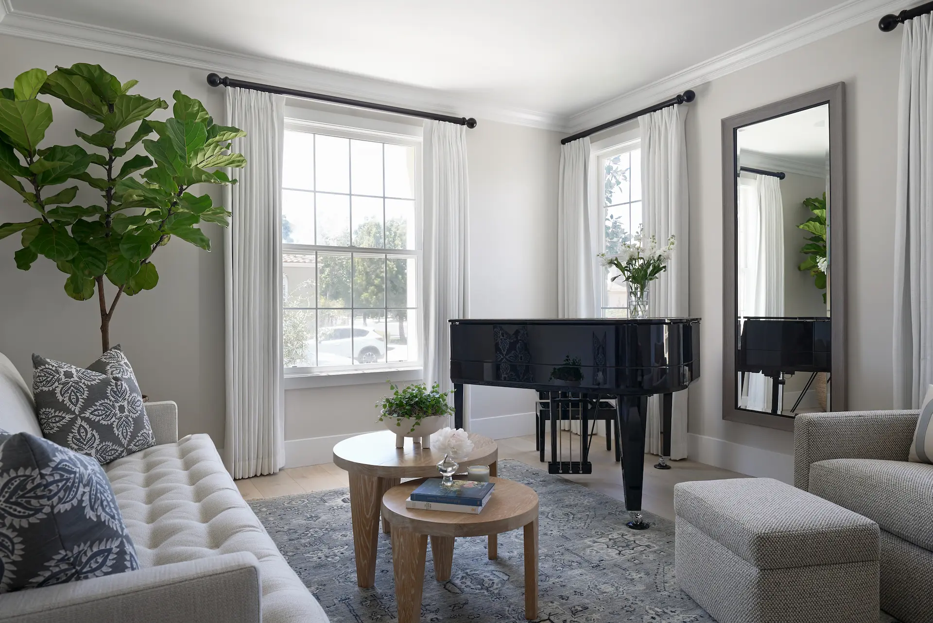 Wide-angle view of the living room from angle one, featuring the piano and spacious layout in the Irvine Contemporary Coastal Remodel. Photo by Todd Huge.
