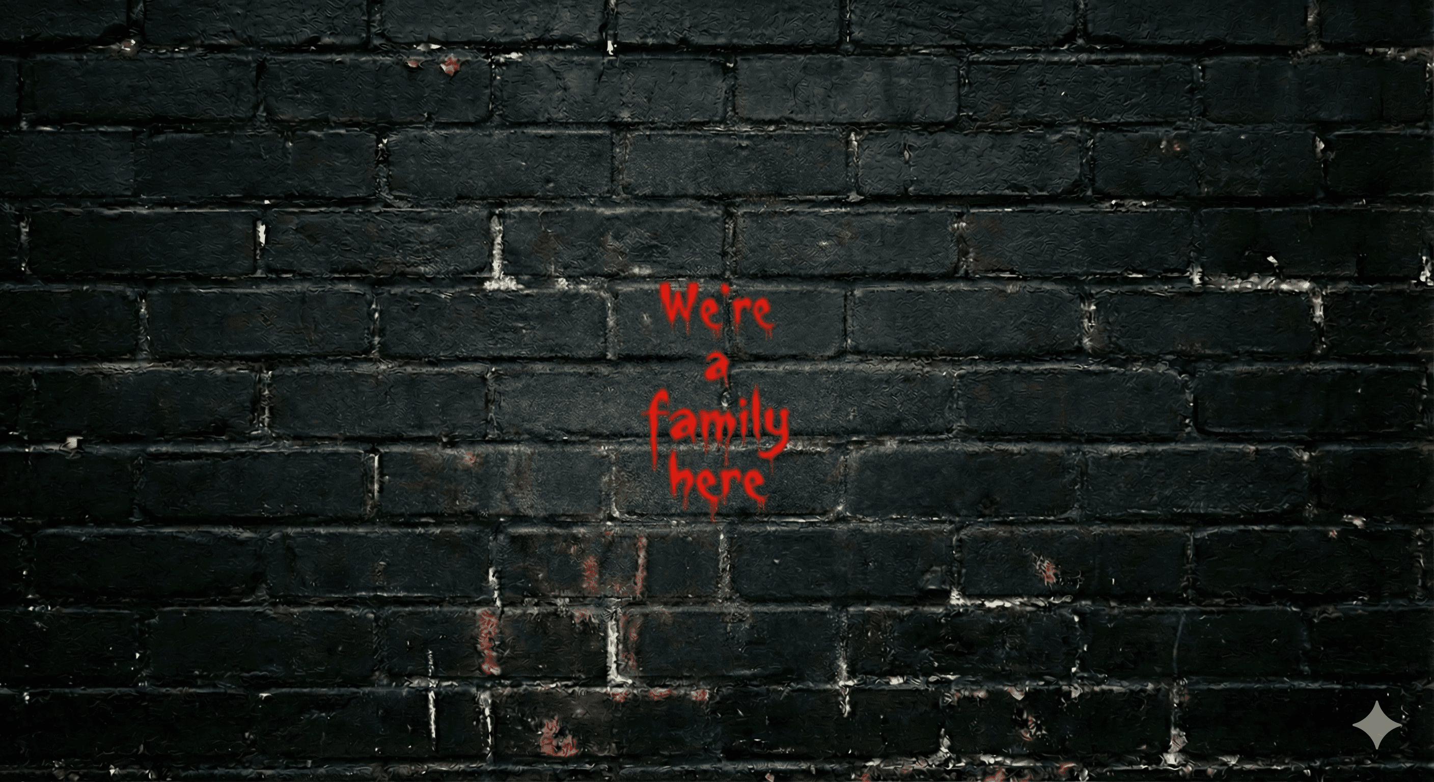 we're a family here spray painted on a black brick wall