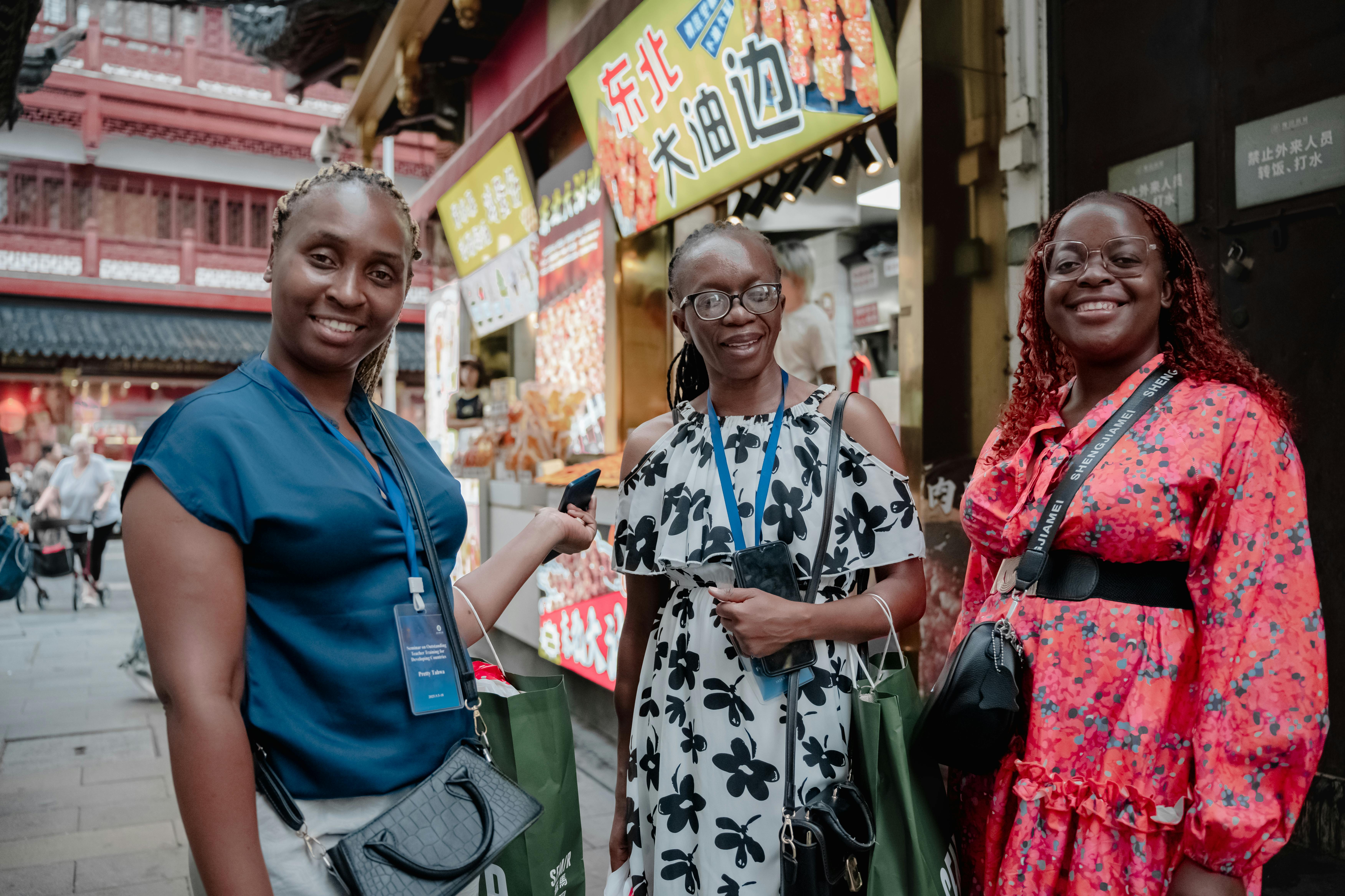 Three foreign tourists at Shanghai street market