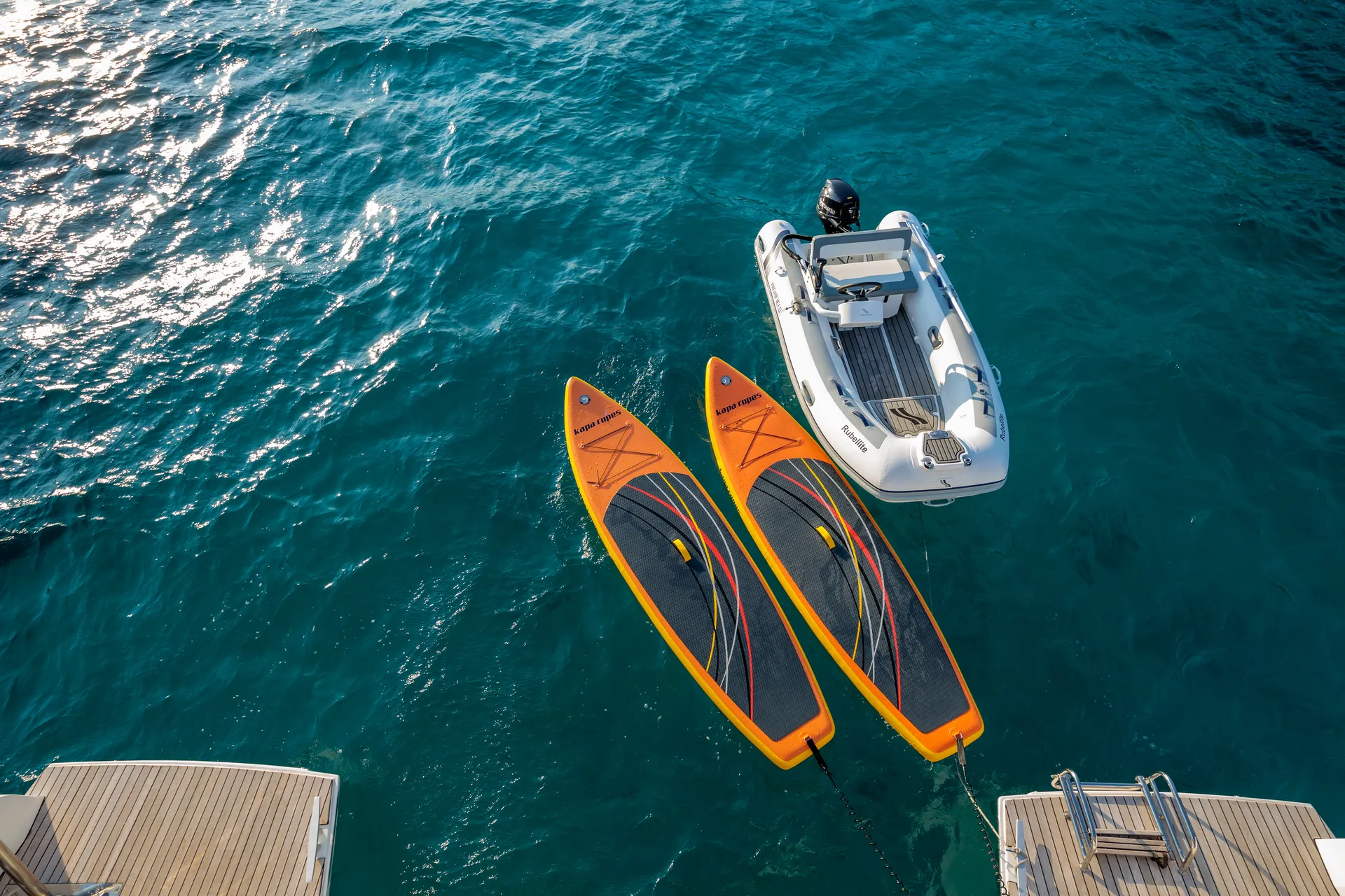 White Rock 36 speedboat with captain at helm cruising calm blue waters near Paros coastline with hills in background.