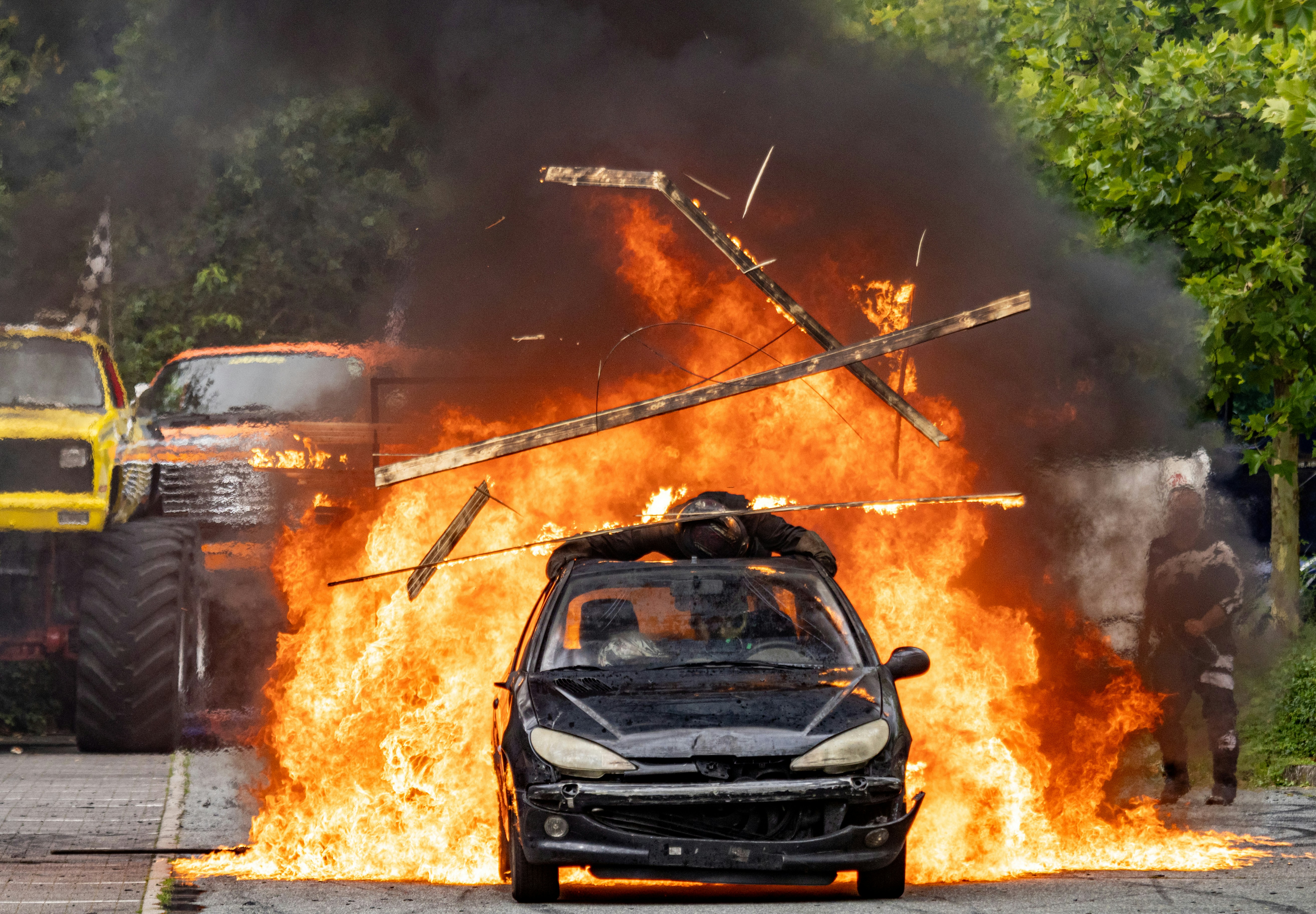 A car is on fire on a street