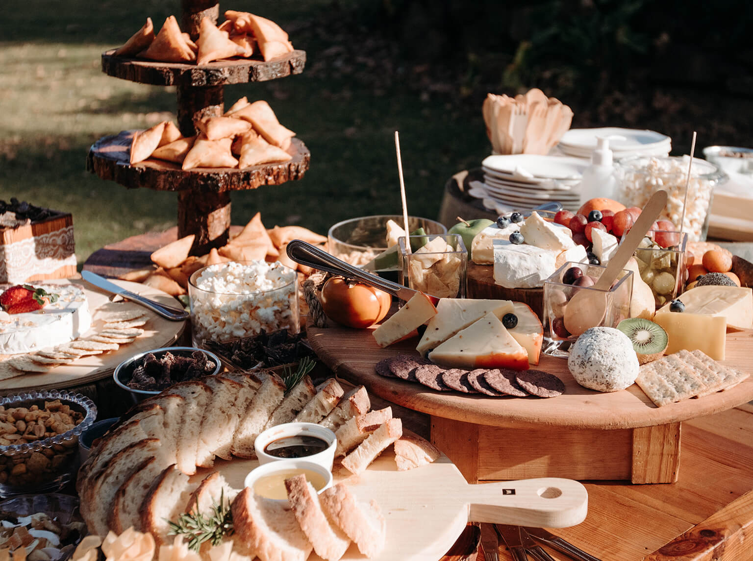 A serene pathway lined with trees leads to a distant building, bathed in warm sunlight.