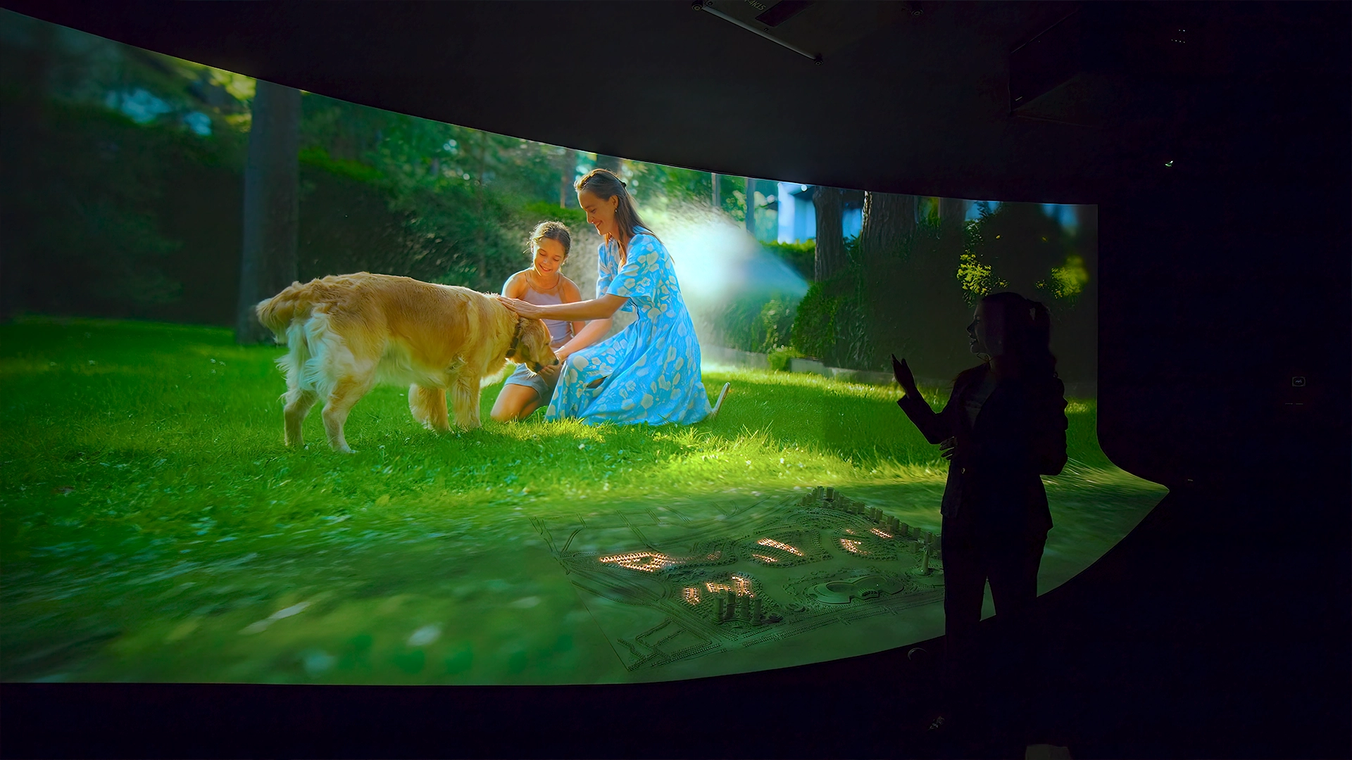 Immersive scene synchronizing projected content with the masterplan experience.
