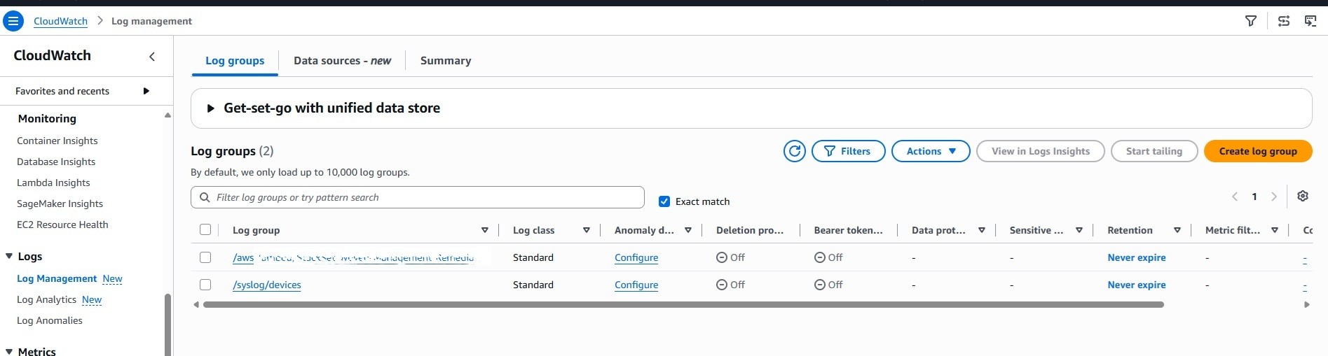 CloudWatch log groups list showing the /syslog/devices destination log group.