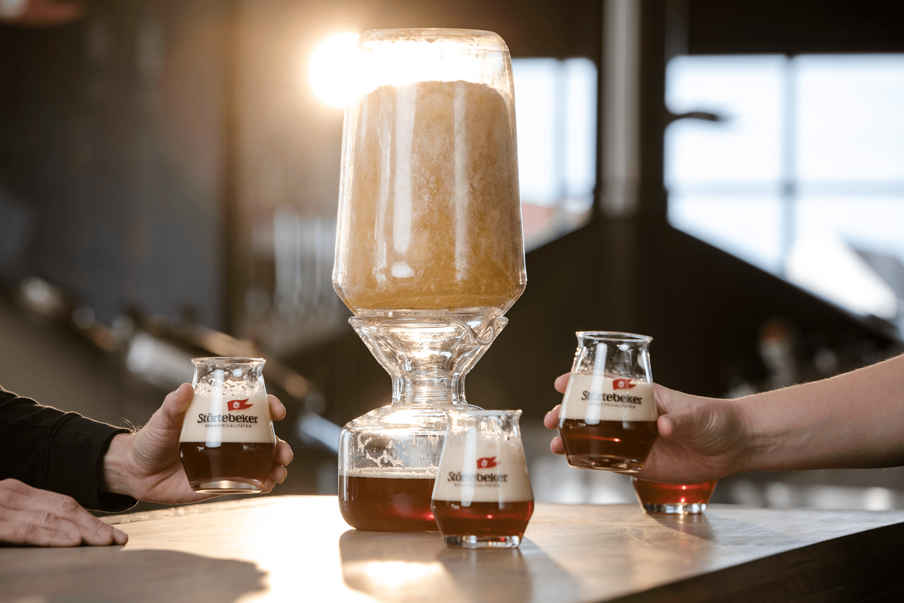 Beer dispenser with glasses being held