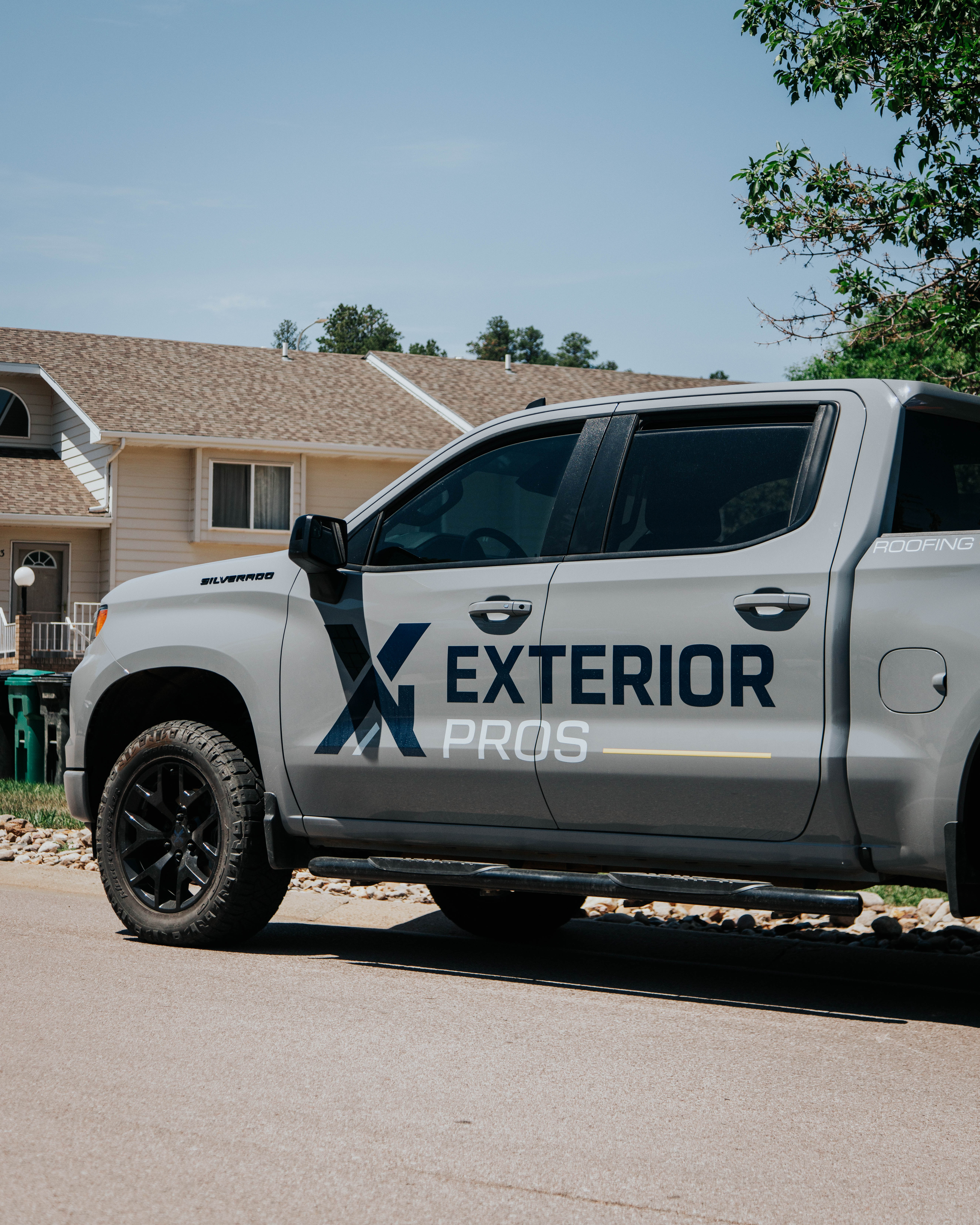 Exterior Pros crew and branded truck working on a home exterior project