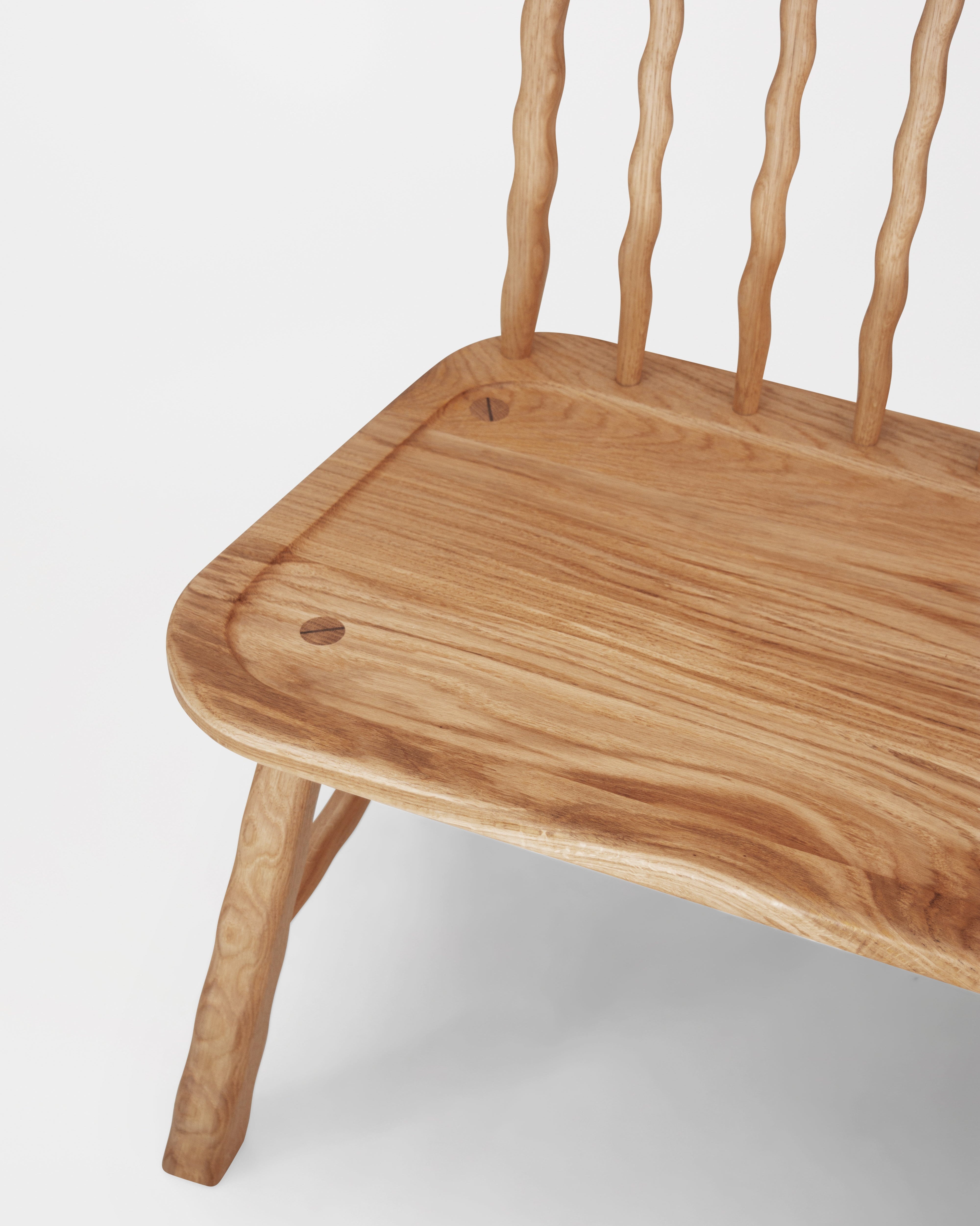 Close up of Windsor Bench in Oak on a white background