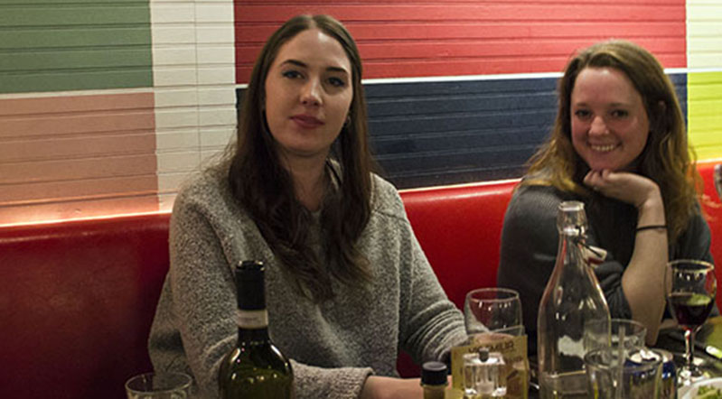 A photo of a group of people siting at a table in a restaurant.