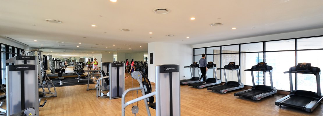 a gym with a variety of cardio equipments