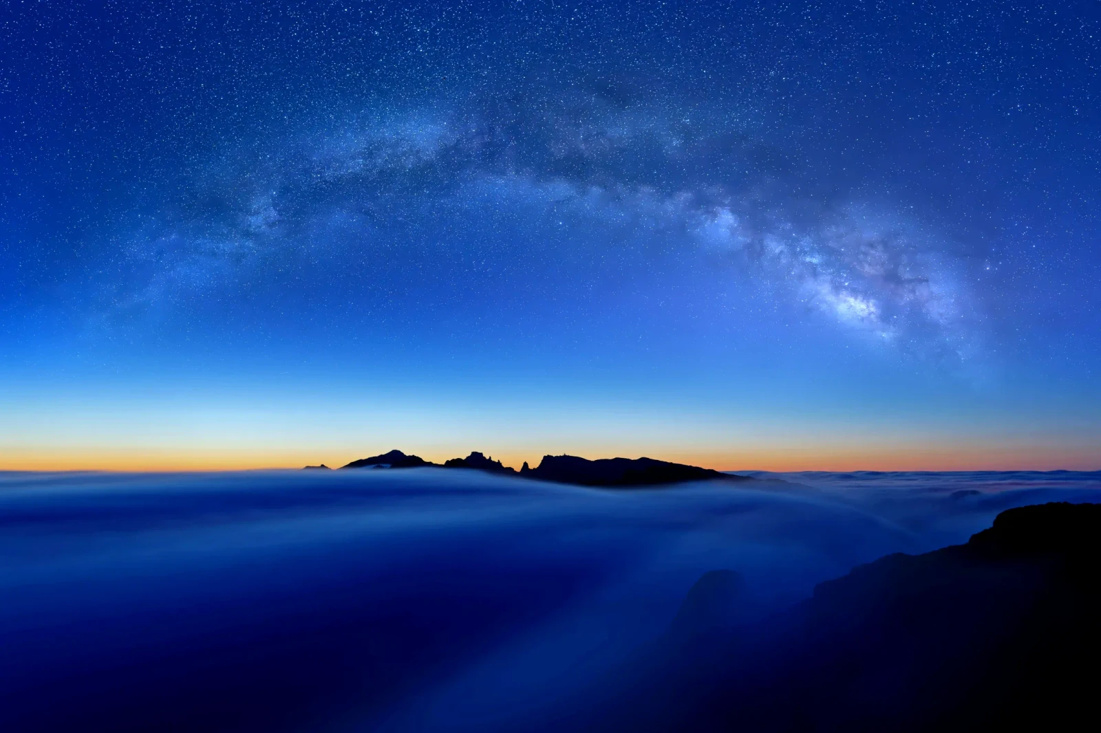 The Milky Way over a sea of cloud at blue hour