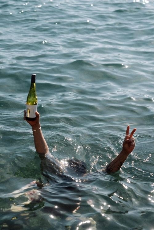 A serene pathway lined with trees leads to a distant building, bathed in warm sunlight.