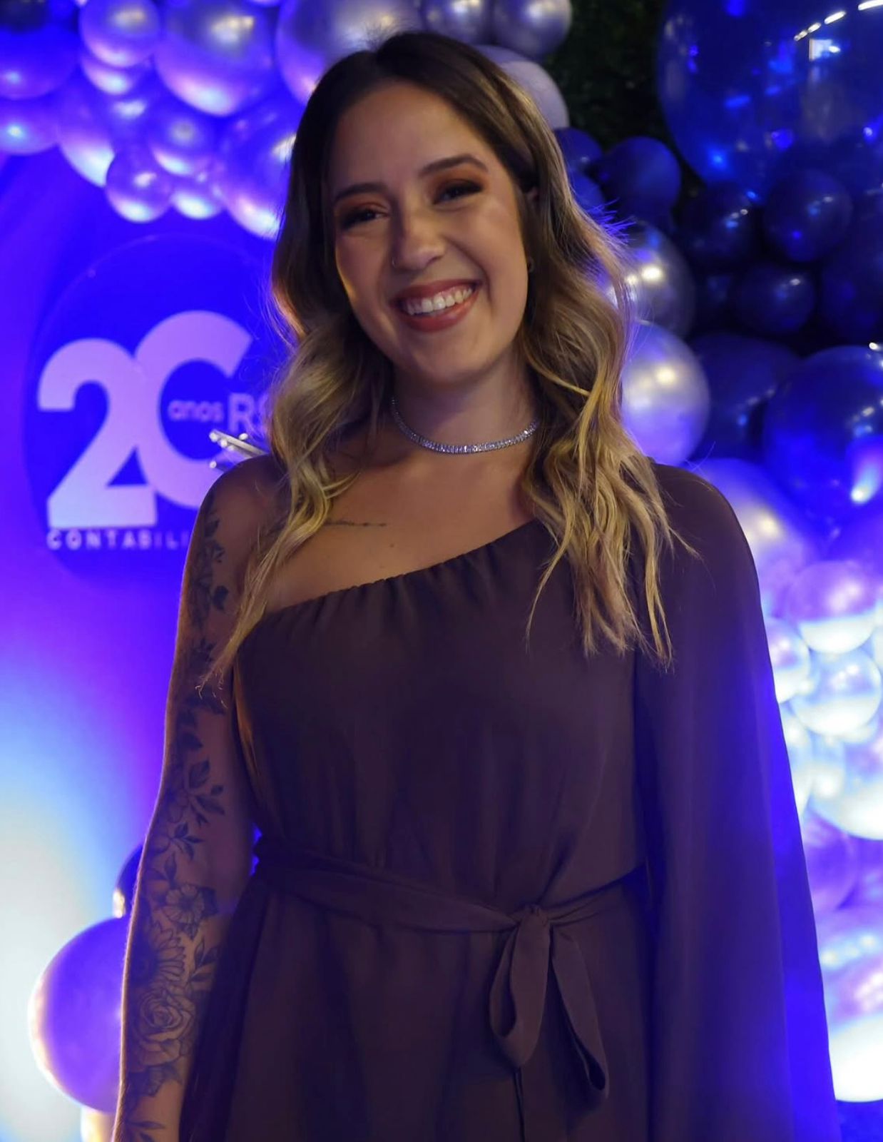 A smiling happy customer with curly hair on a blue background