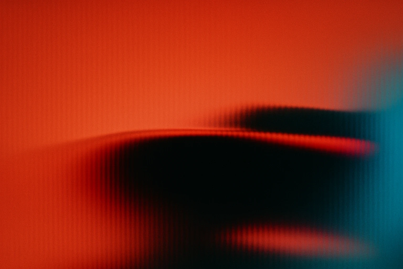 Artistic portrait with red and blue lighting creating a dramatic effect