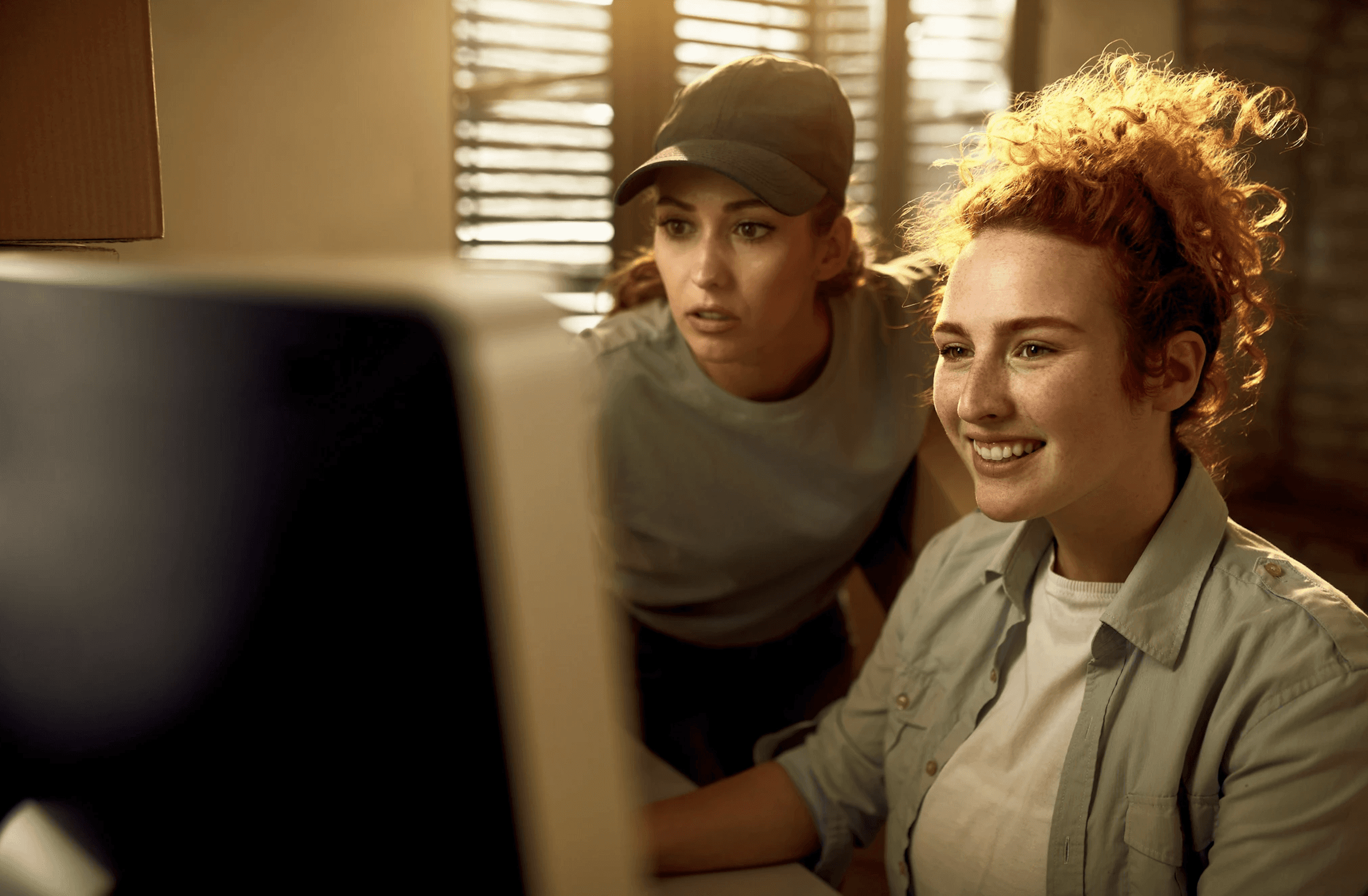 two women looking at computer screen
