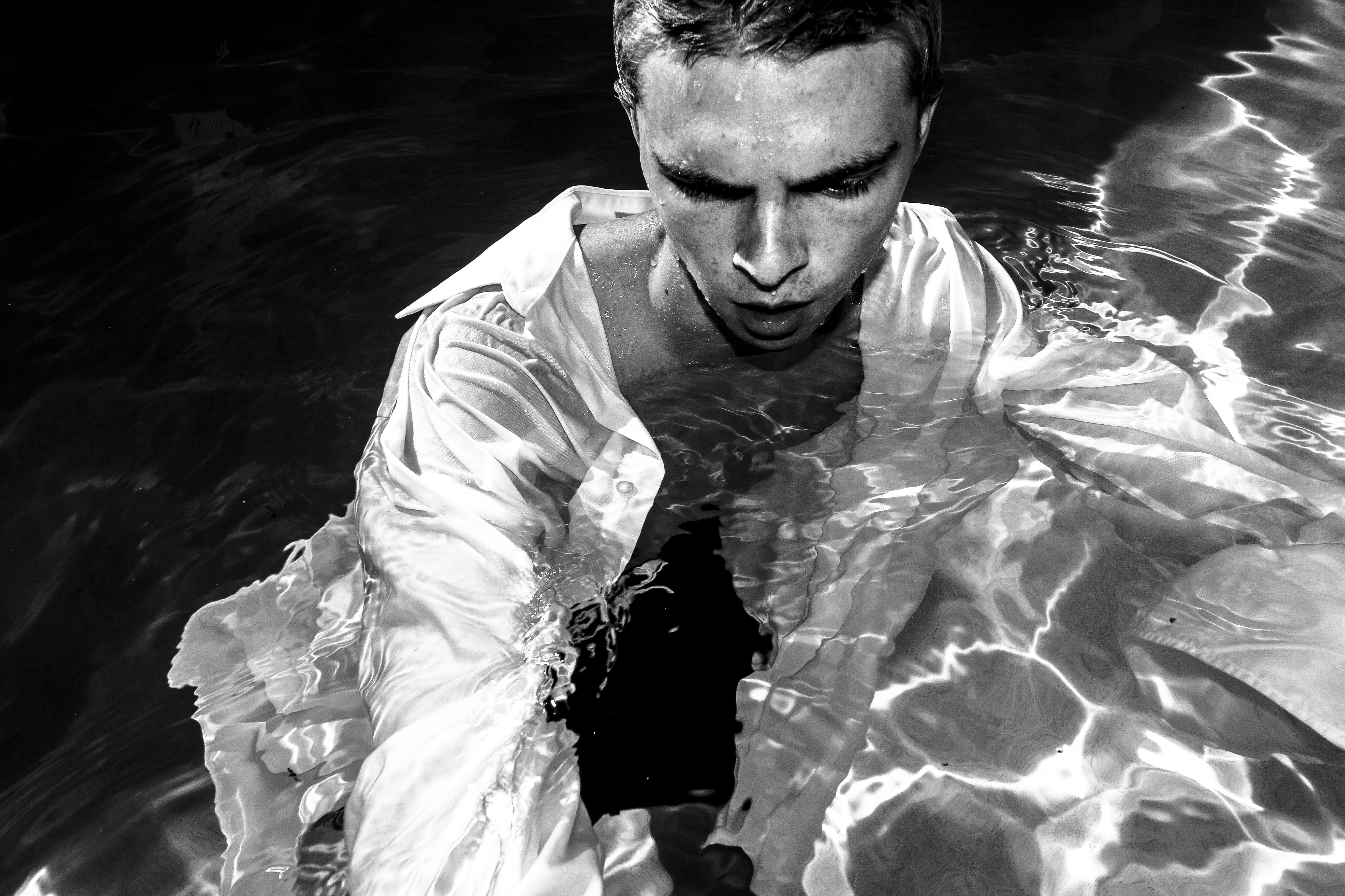 Stack of modern books and magazine with minimalist cover design on leather chair