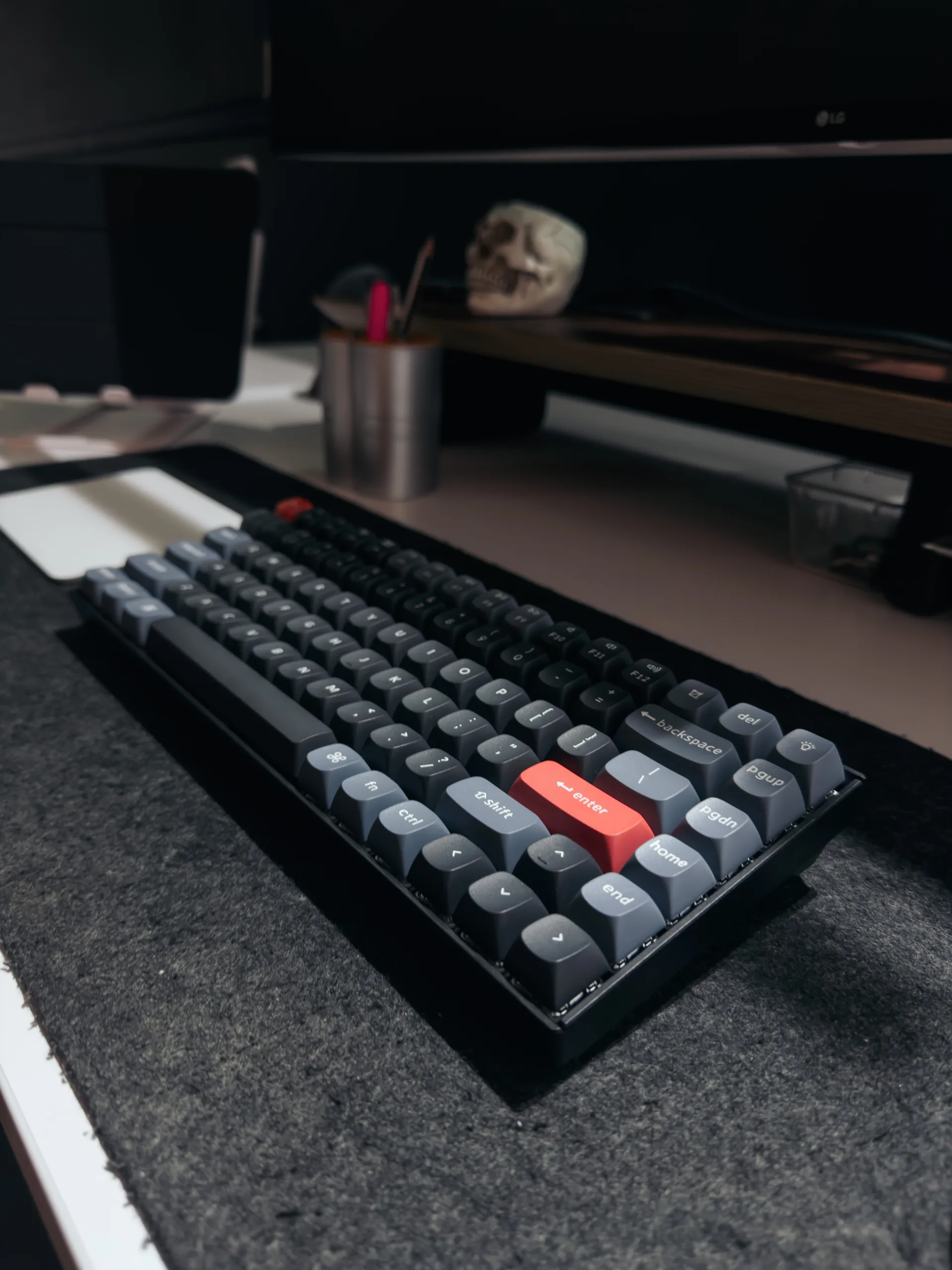 A person in a winter coat and furry hat walking along a snow-covered path through a forest of frosted trees.