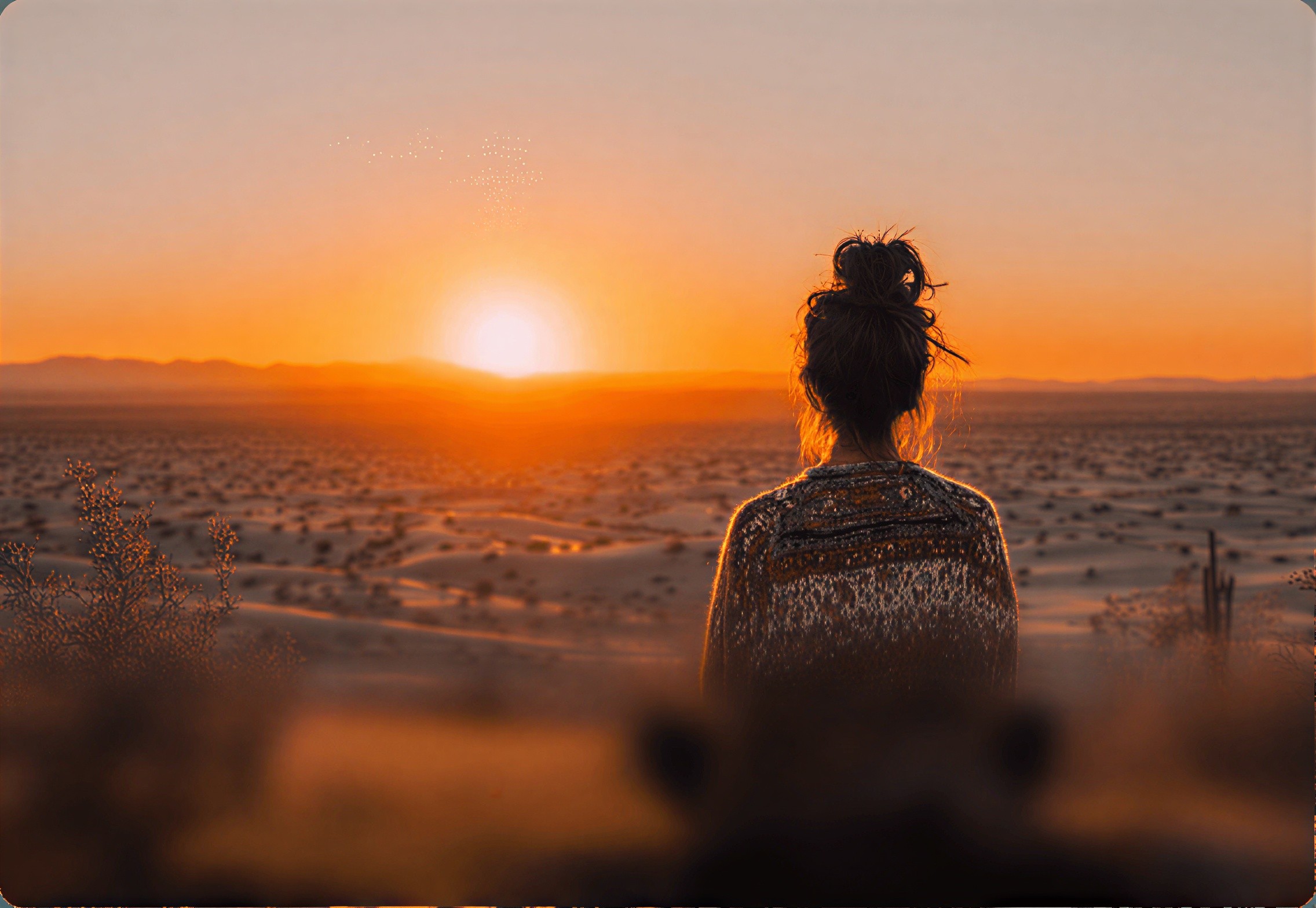 Red-haired woman relaxes with eyes closed in dramatic sunlight shadows.