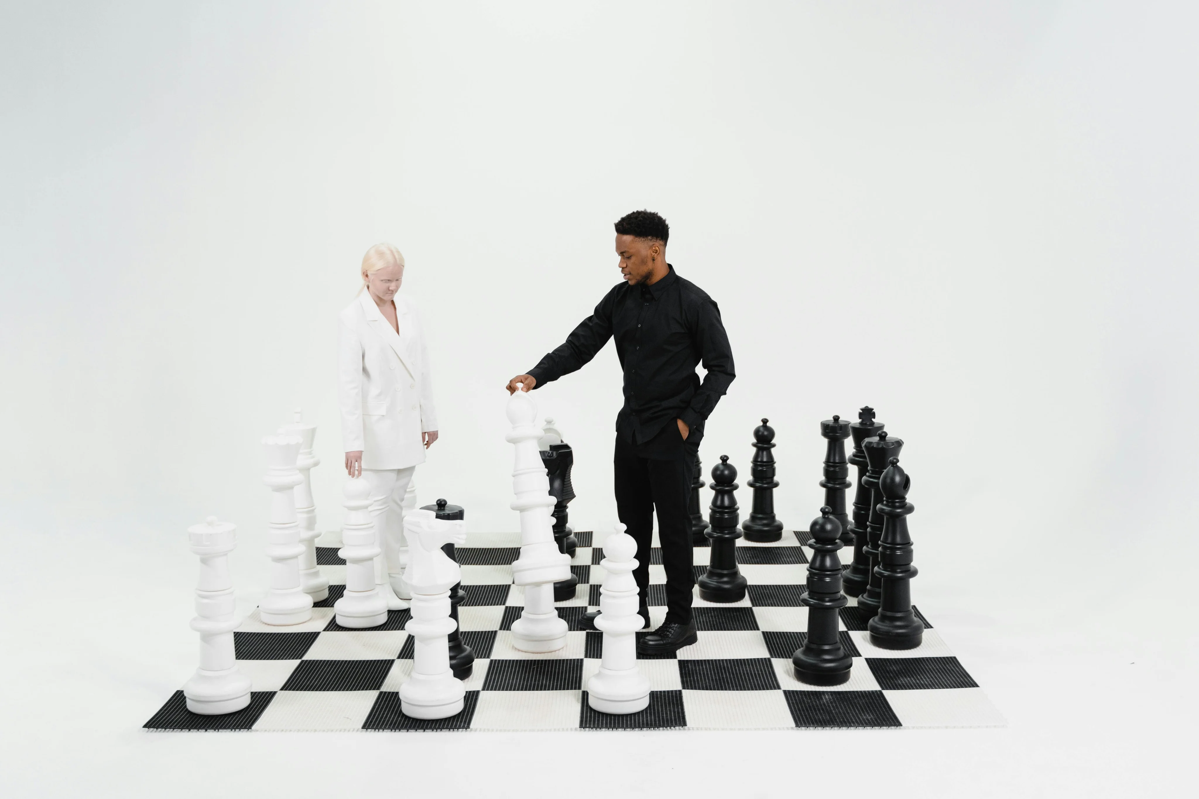 Nathan Mitchell & Lea Cole standing on chess board